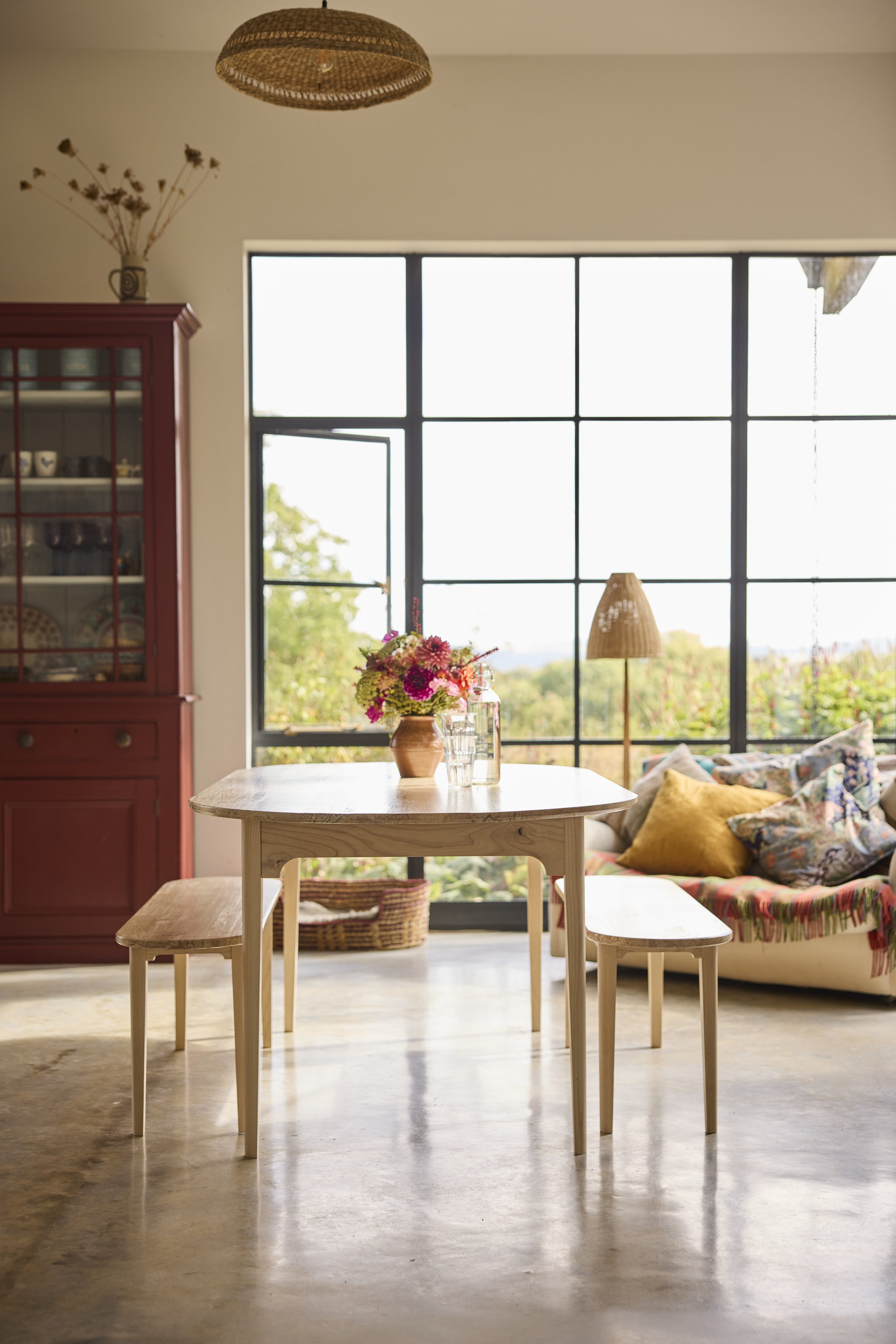 A solid wood dining set in a light filled home made from pale British timbers ash and silver birch giving it a Scandinavian vibe