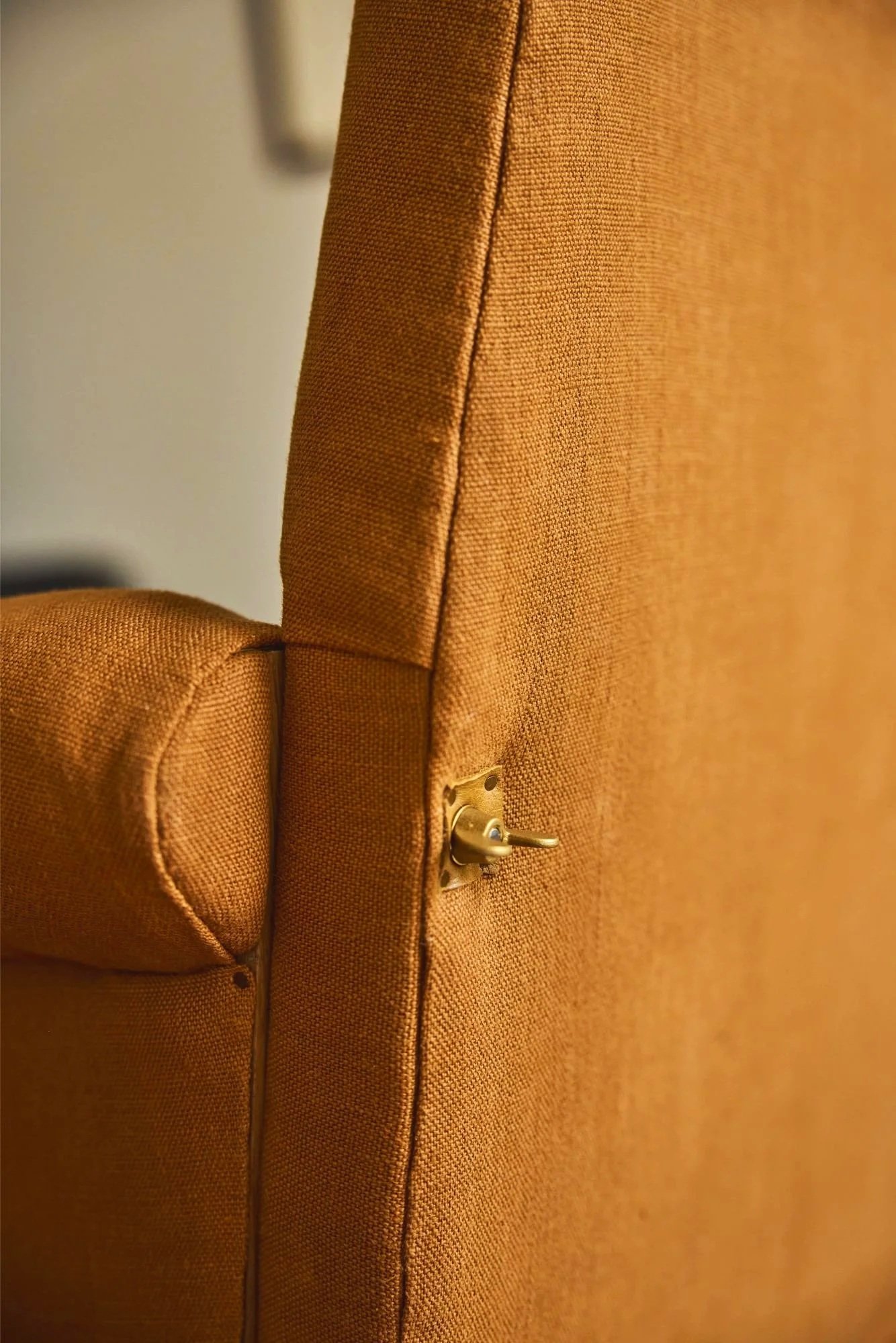 Close-up of the rear detailing of The Aldan Loveseat made to be bolted together this image shows the solid brass detailing in the bolt