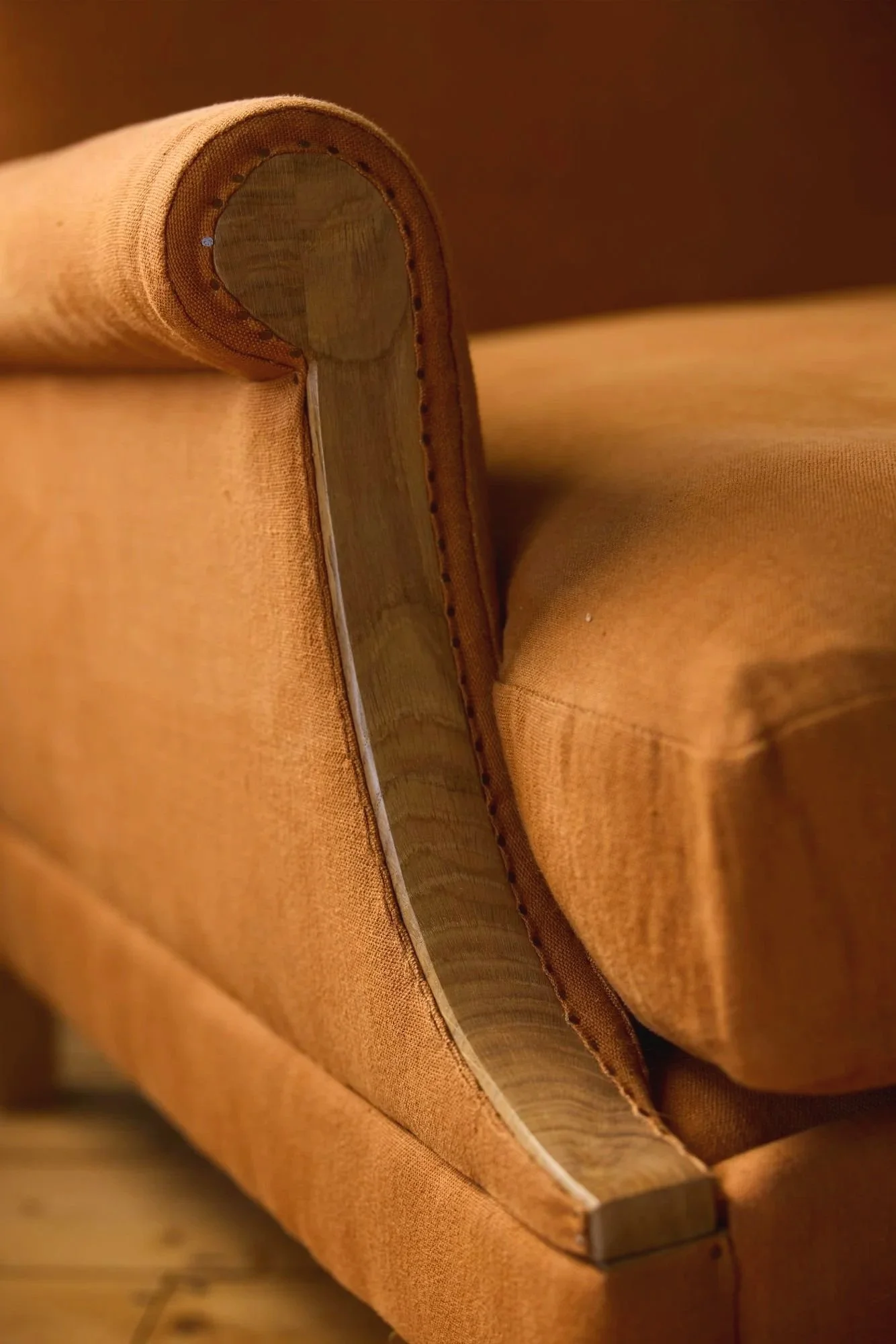 detail of a hand finished scroll arm made for a bespoke sofa and armchair by Trew and Bold