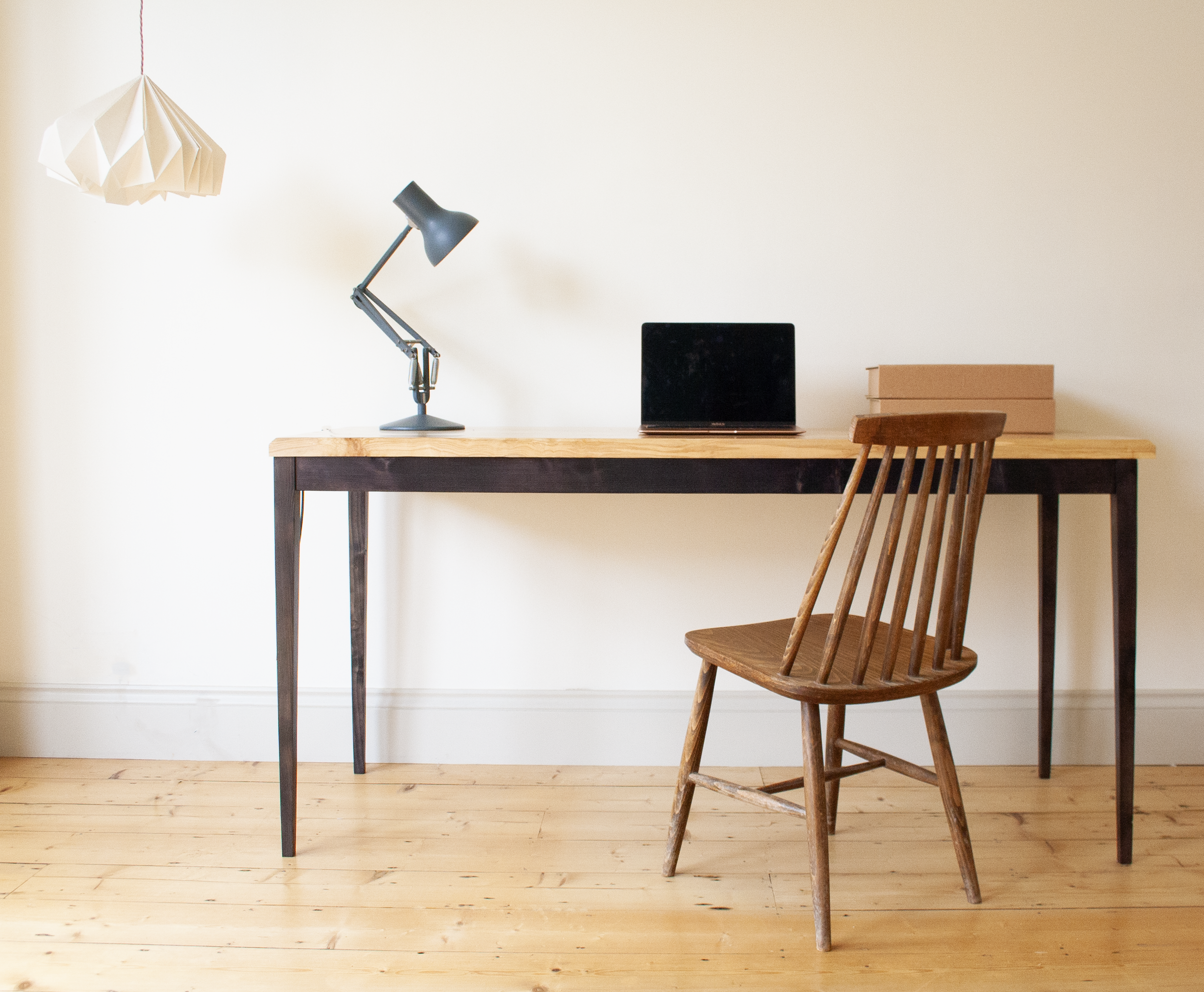 The Calder table with elegant black legs and a spalted wood table top