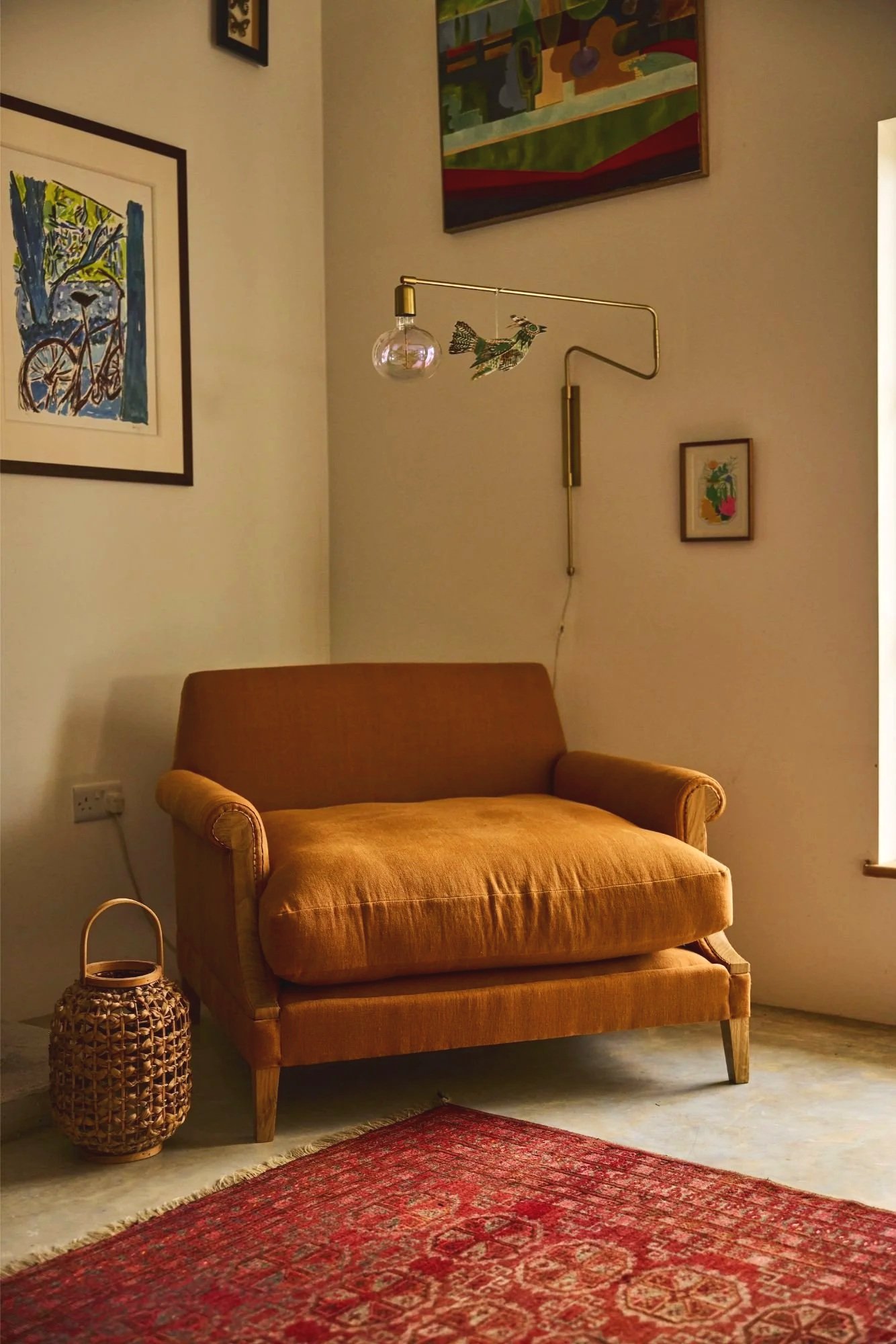 A very large comfortable orange armchair made in solid oak traditionally upholstered in orange linen