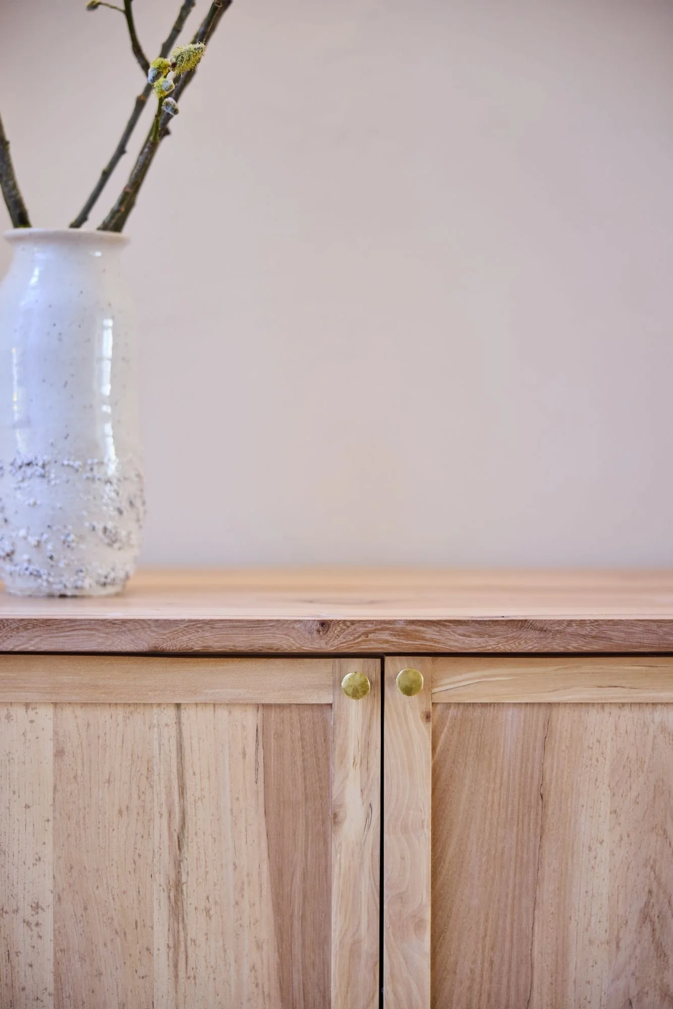 detail of slim shaker doors on a custom alcove cabinet made with brass door handles made in a workshop near Bristol