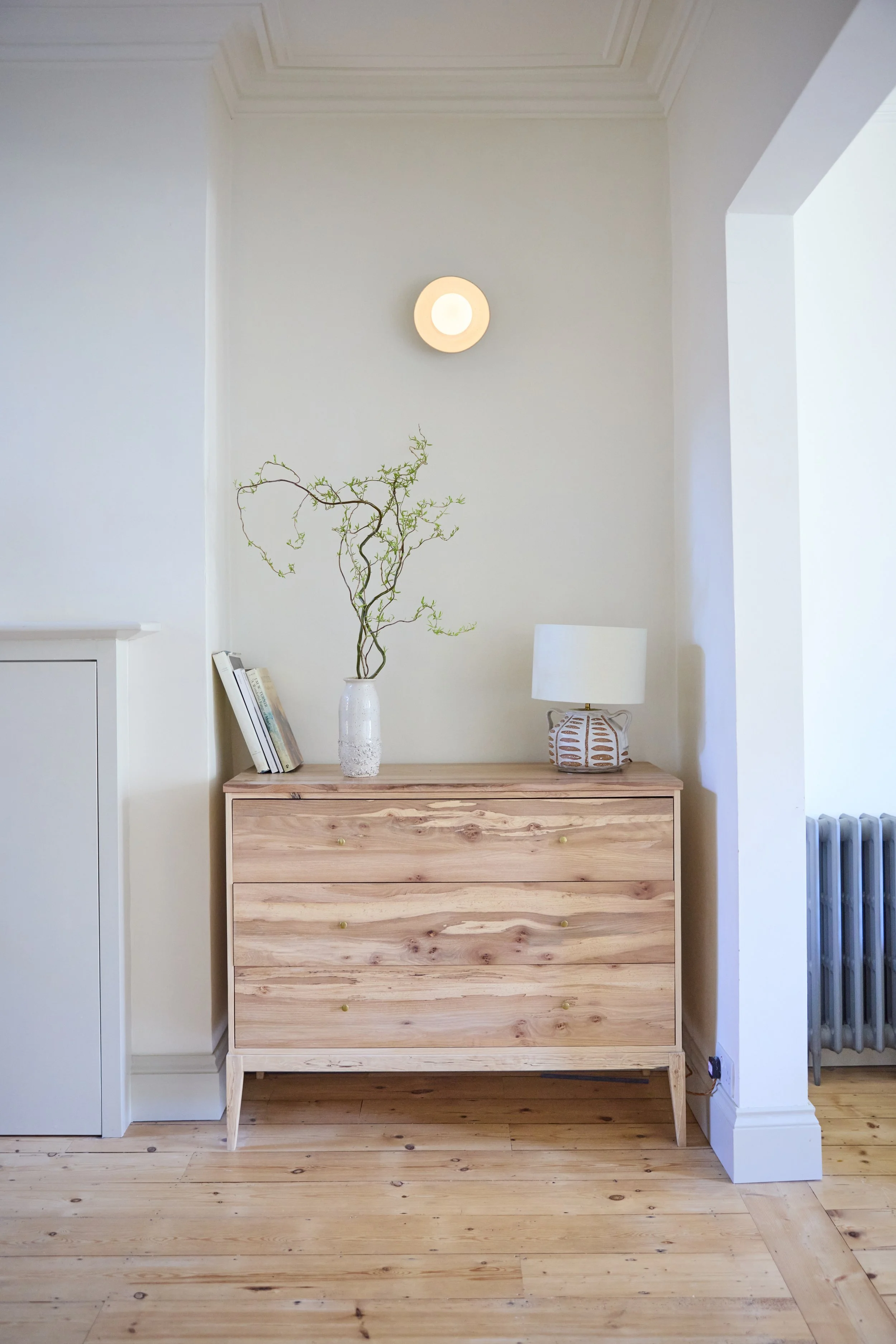 A bespoke chest of drawers made for an alcove to house a families art material collection. The design uses rare spalted elm and silver birch