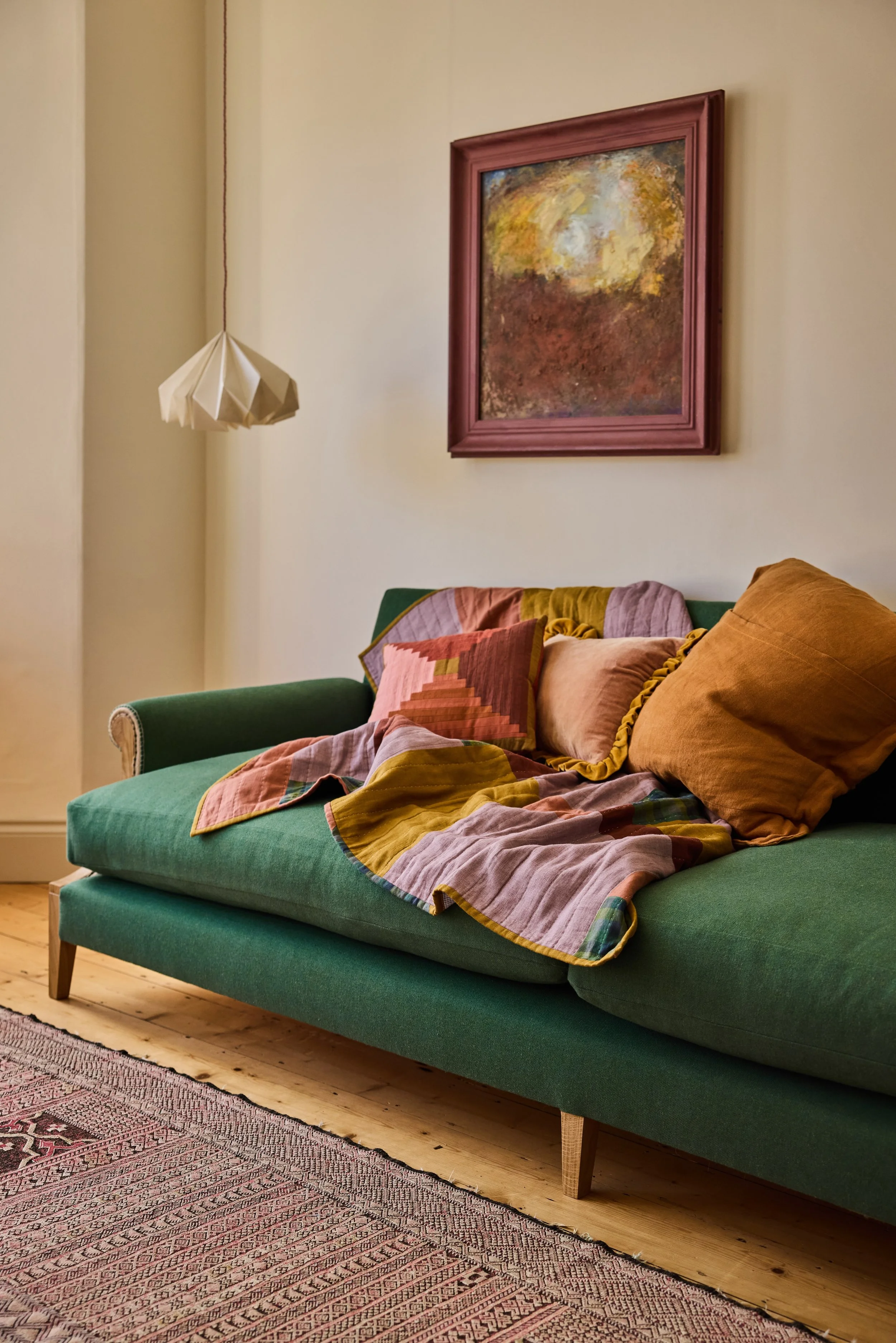 A bespoke solid oak sofa designed and made in a workshop near bristol with an exposed solid wood frame and upholstered traditionally in a natural green wool fabric. This sofa is and extra large bespoke length at 2.8m long