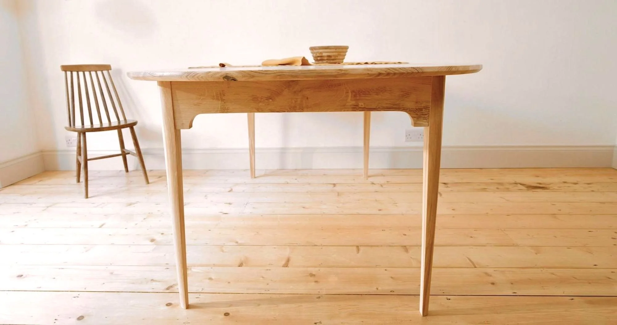 Detail of the Mid-Century inspired details on the bespoke Orwin Extending table made from solid british oak