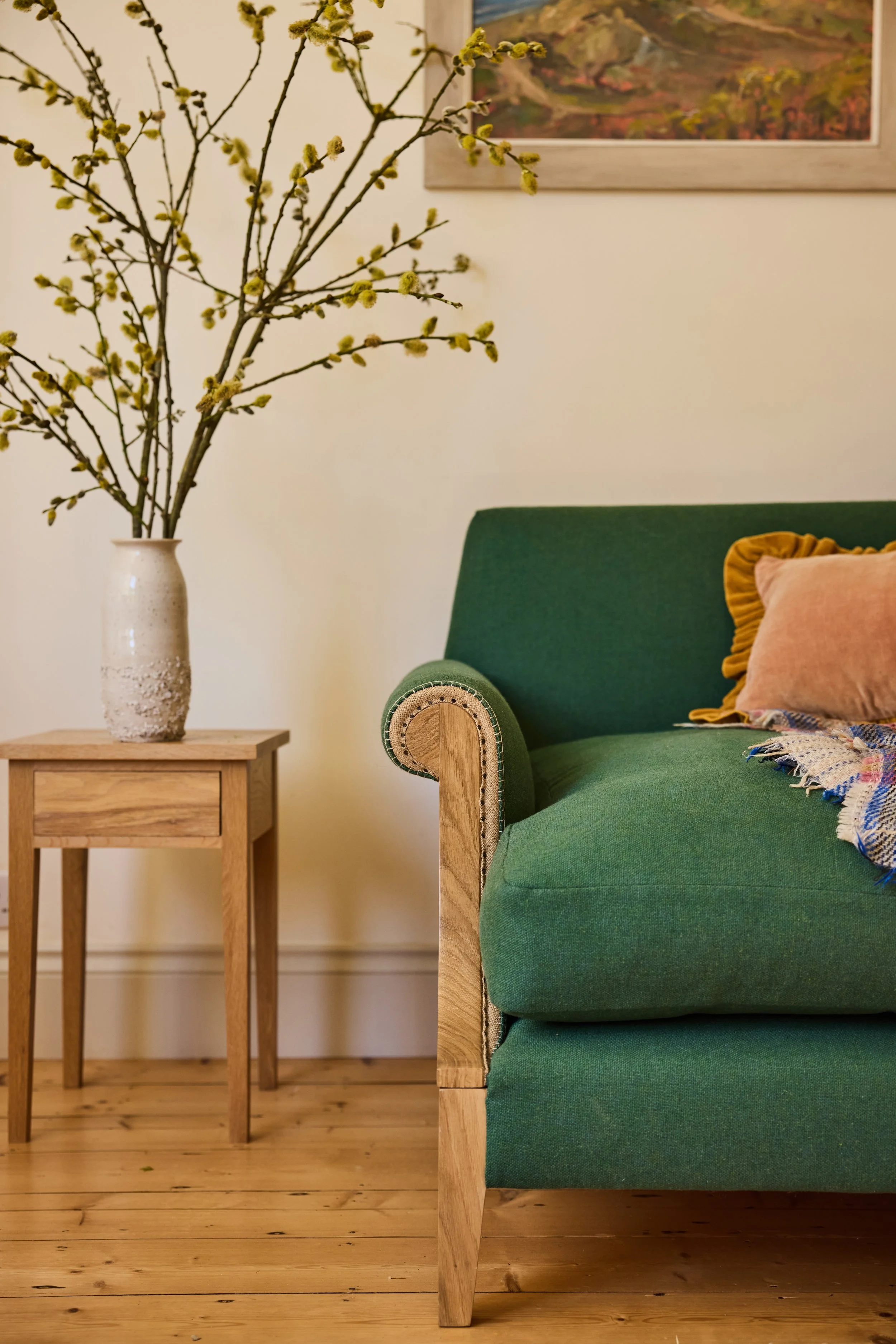 Scroll arm detail of a solid wood sofa hand finished in oak. All made in a workshop between Bristol & Bath
