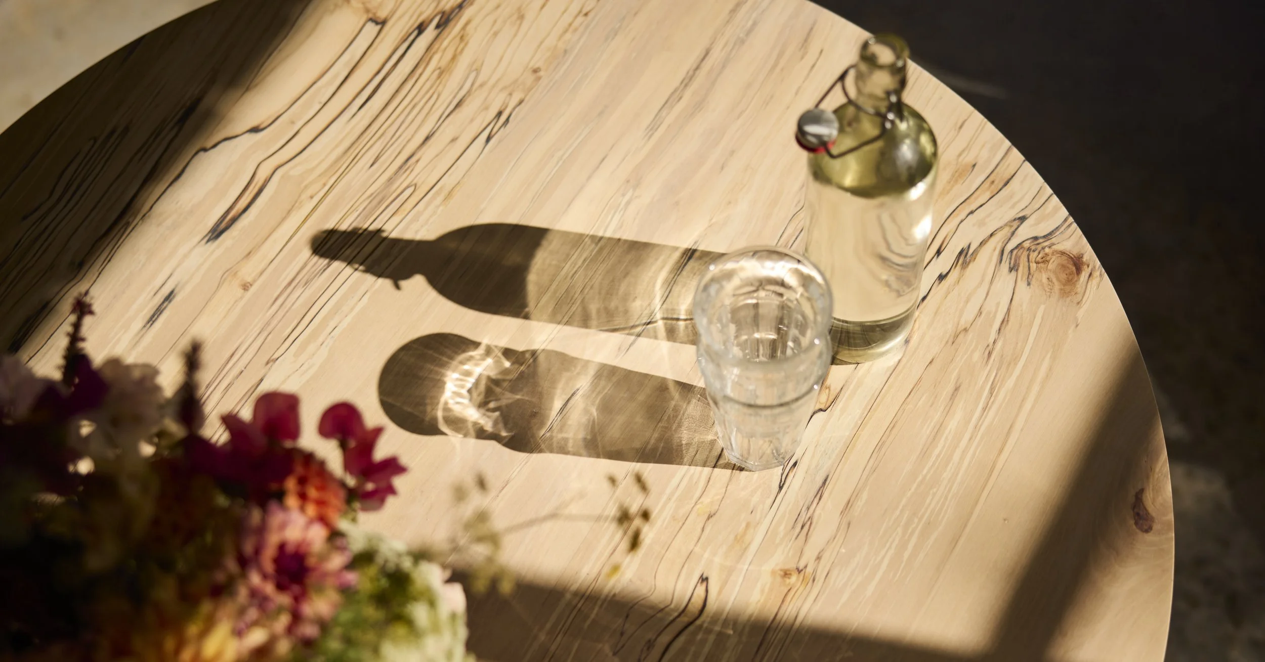 Sunlit table top of The Orwin handmade with beautiful spalted silver birch in our Bristol workshop