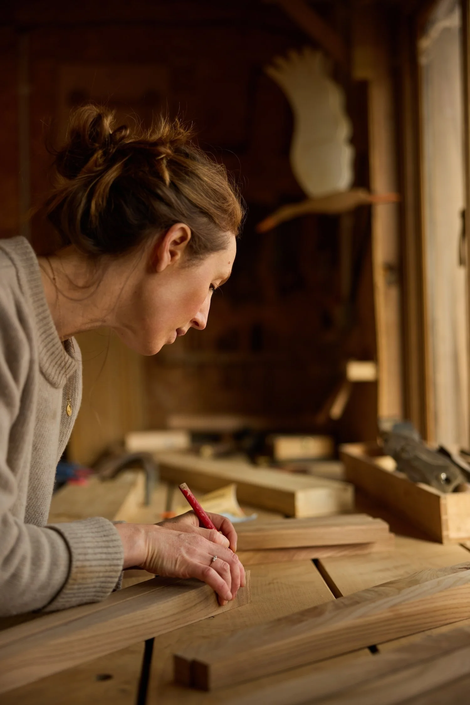 Trew & Bold founder Emily marks up solid wood components in her Bristol Workshop