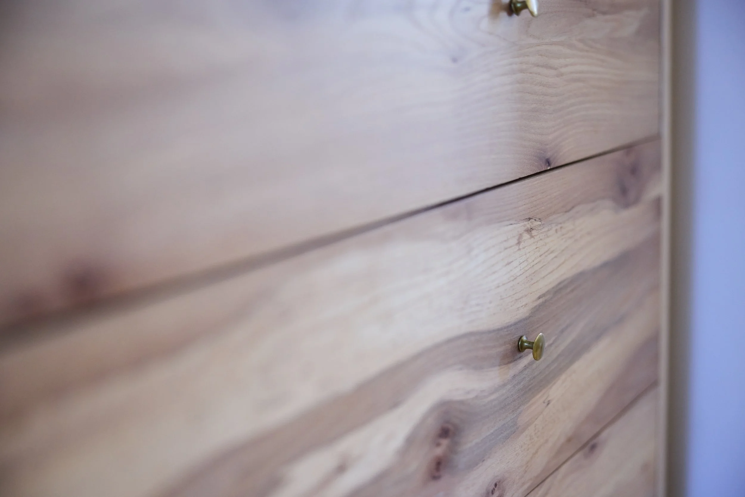 Detail of spalted elm drawer fronts with brass drawer pulls but Optimum Brasses