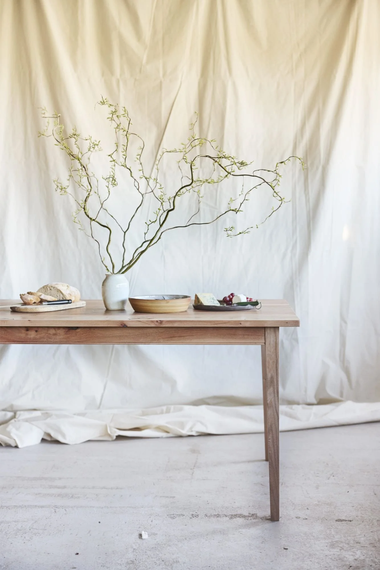Bespoke elm dining table on a minimal background handmade in a workshop in between bristol and bath