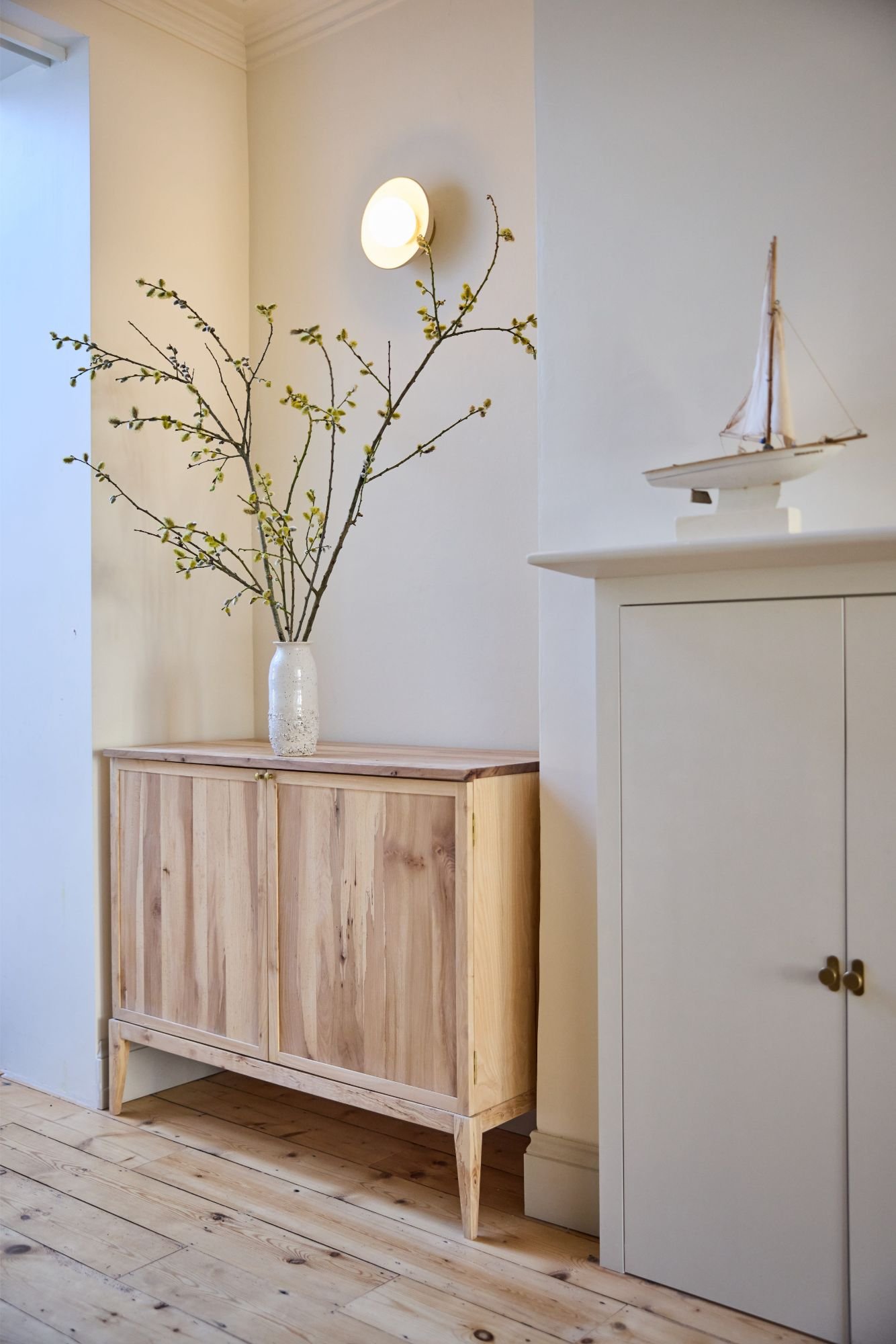 Custom alcove cabinet made in solid wood and styled in a neutral minimal way