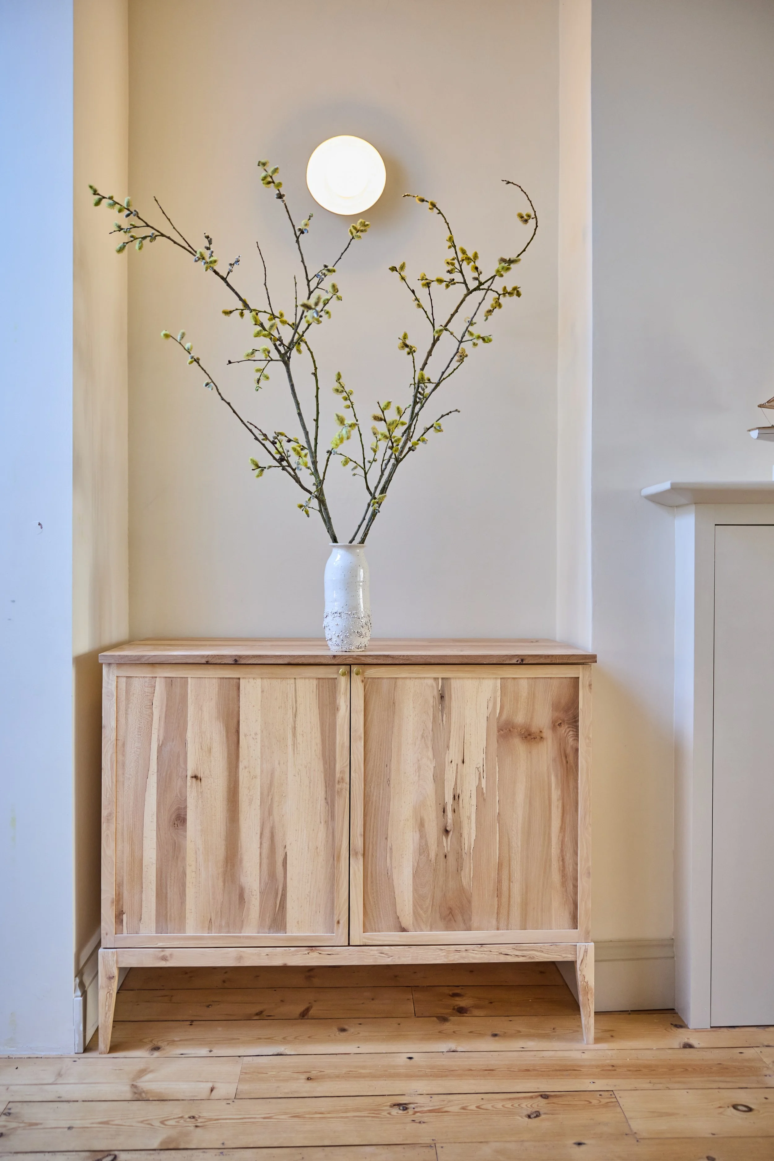 A bespoke cabinet sitting in victorian terrace in Bristol. One half of a pair made from solid timber
