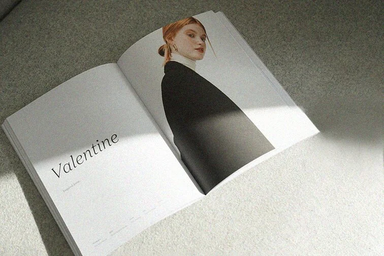 Open magazine with a portrait of a woman on the right page and the word 'Valentine' on the left page.
