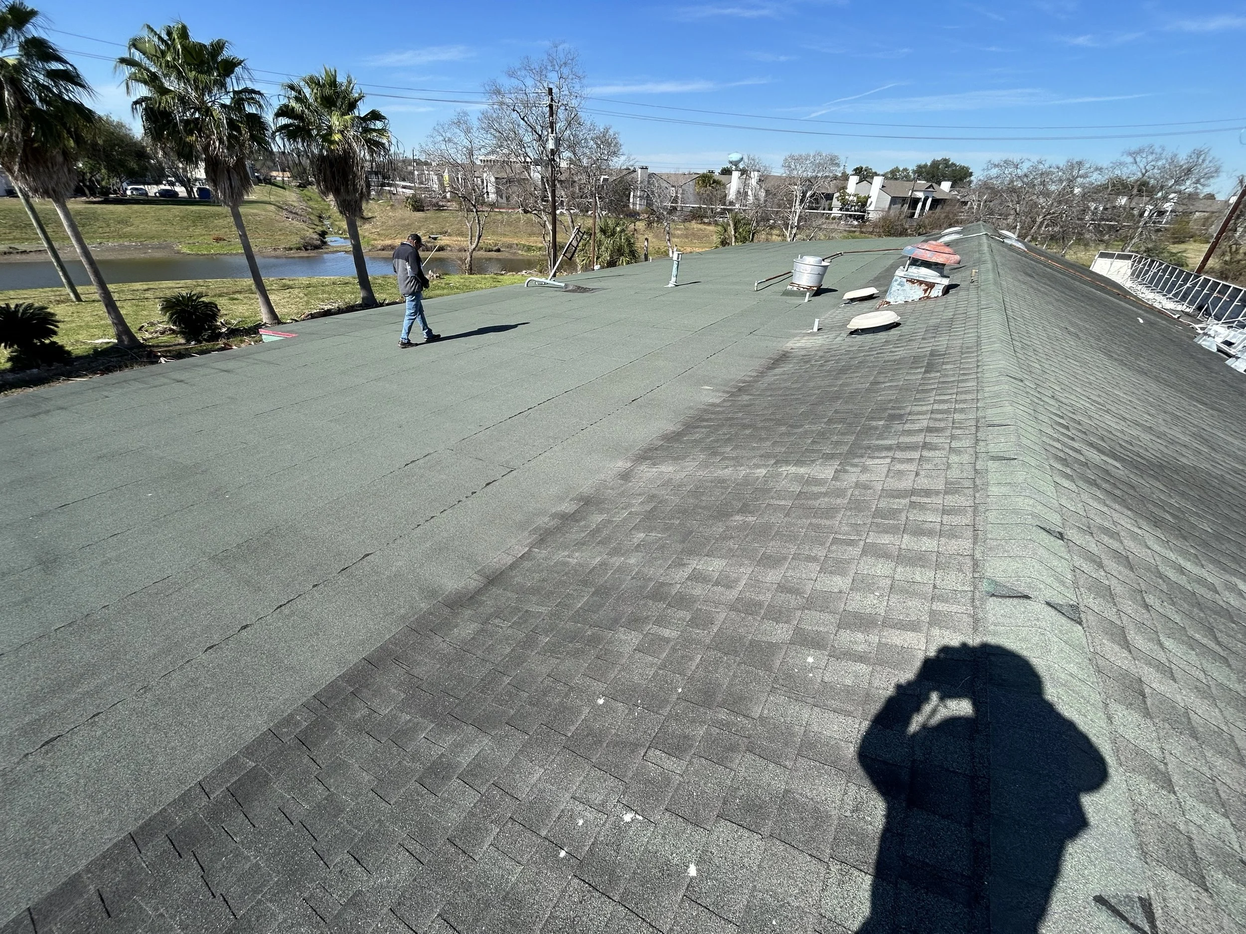Commercial roof with both shingle and flat roof.