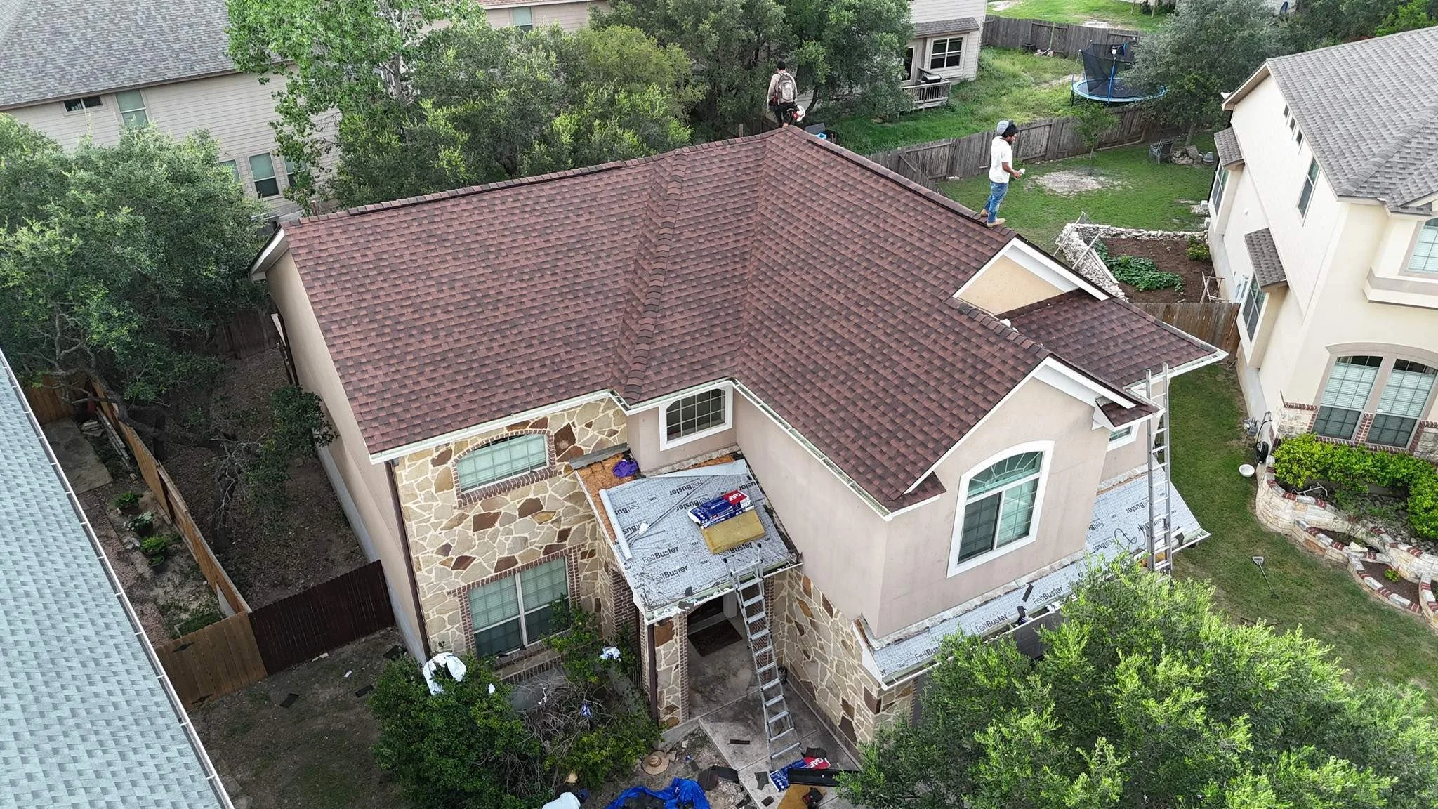 An aerial view of a house almost complete with a new roof.
