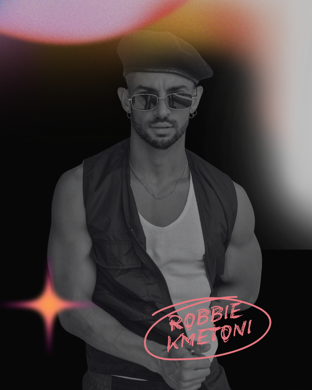 Black-and-white photo of a man wearing sunglasses, a beret, a sleeveless vest, a white tank top, and jewelry, with a neon pink sign reading "ROBBIE KMETONI" in front of him, against a dark background with colorful light flares.