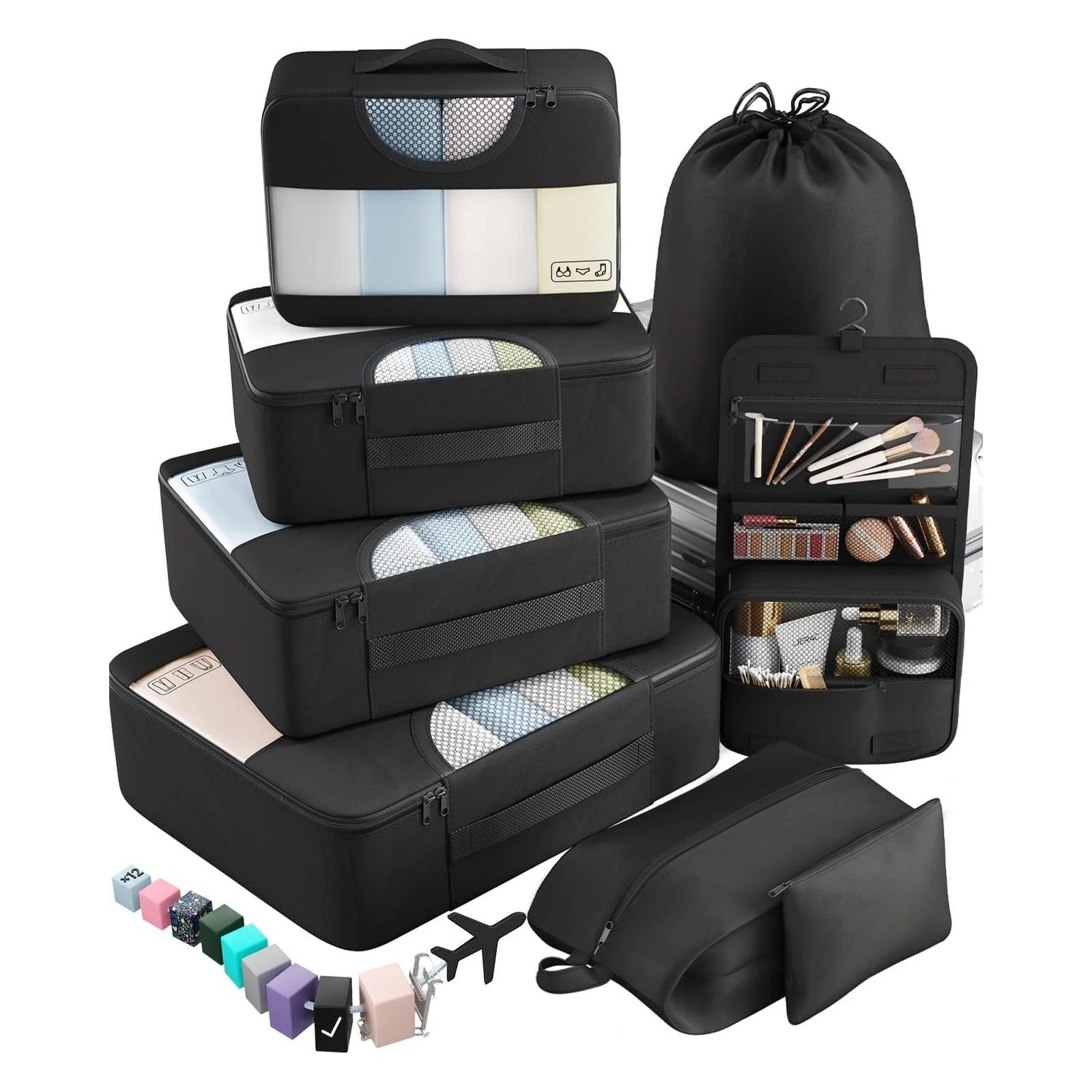 Travel packing accessories including black suitcases, organizers, makeup bag with brushes, small containers, colorful blocks, and travel tags.