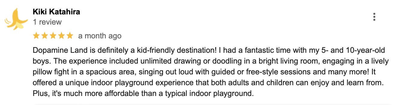 Screenshot of a Google review for Dopamine Land from Kiki Katahira, giving five stars and describing a kid-friendly indoor playground experience with activities like drawing, pillow fights, singing, and free-style sessions.