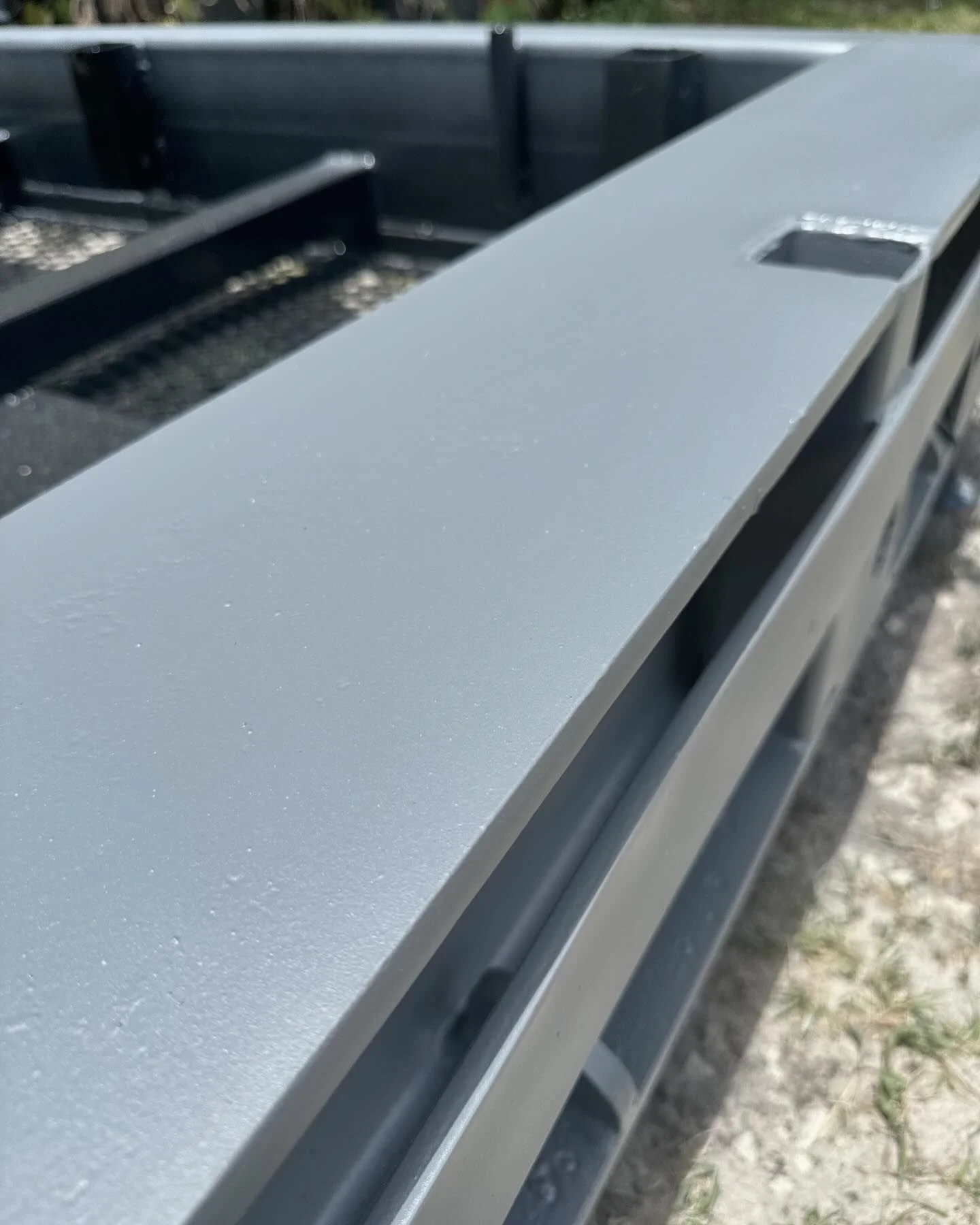 Close-up of a metallic gray surface on a metal structure or equipment outdoors. freshly painted after sandblasting.