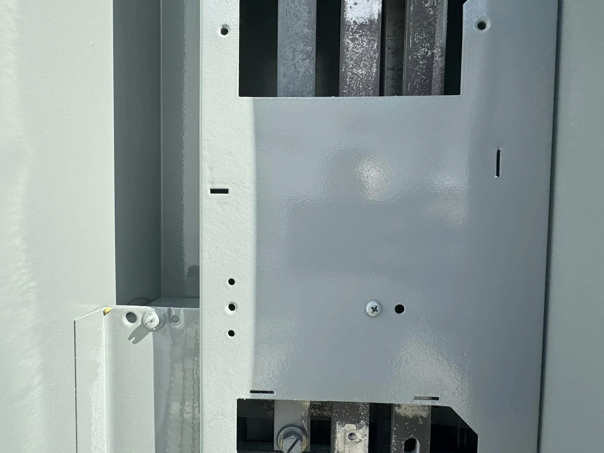 Close-up of an electrical panel box with some wiring visible inside.
