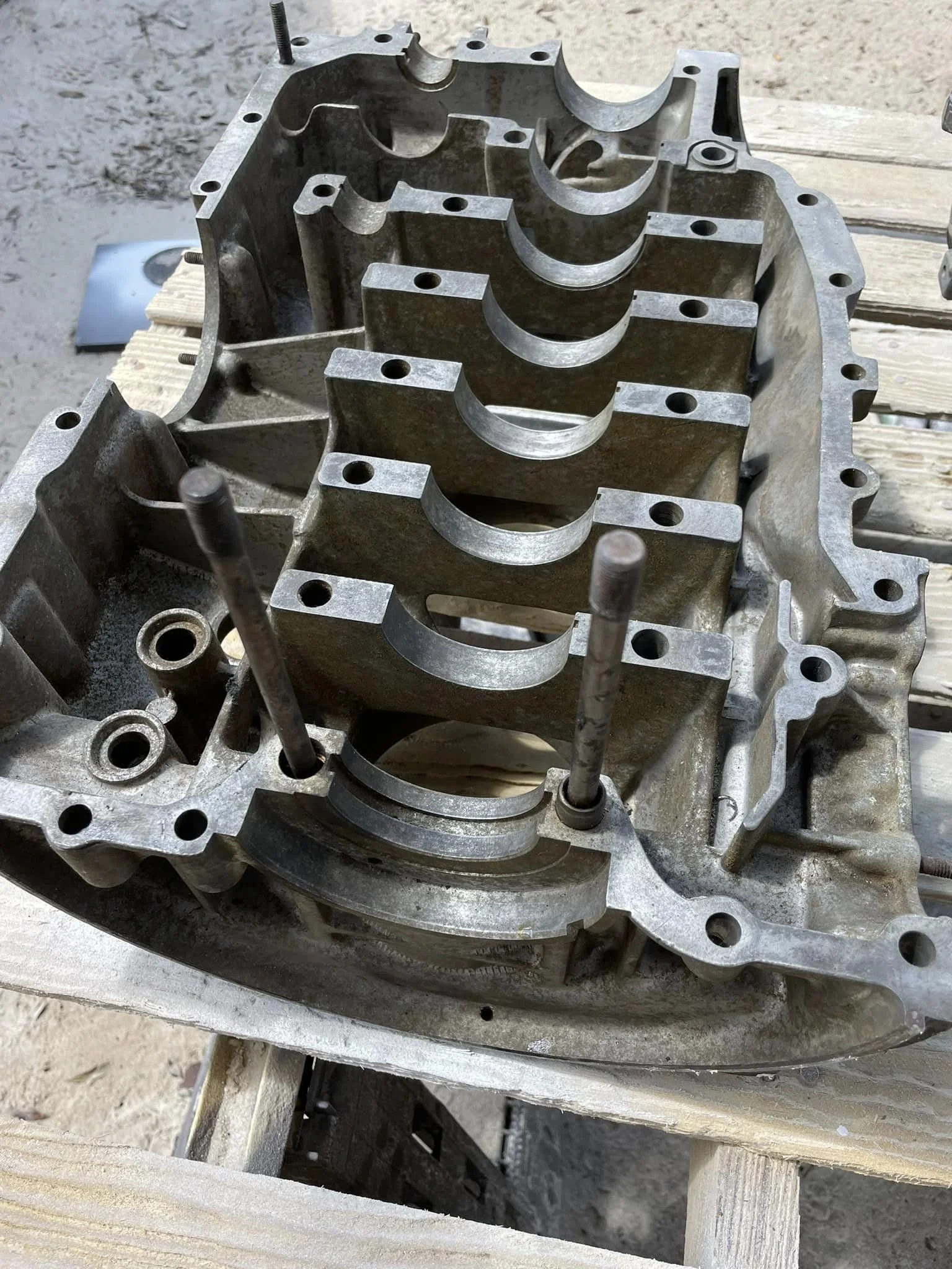 Metal engine block on a wooden workbench.