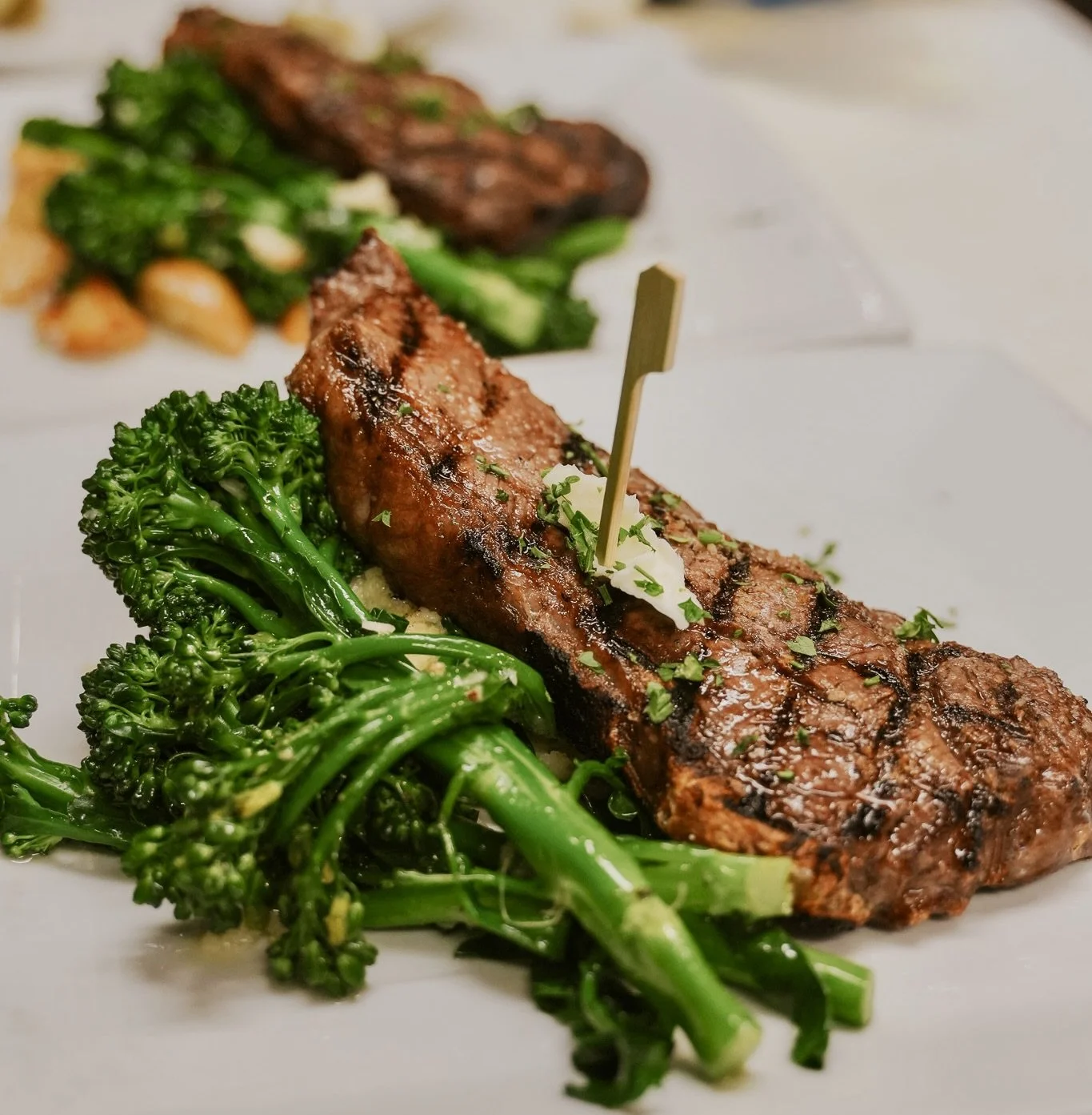 Grilled steak with broccoli florets and mashed potatoes on a plate.