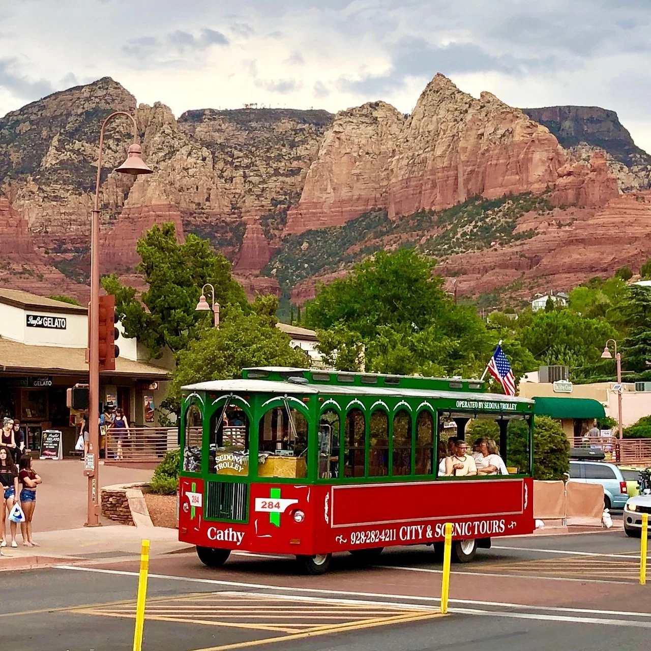 The Sedona Trolley starts its tour along State Route 89A with Sedona's red rocks in the background.