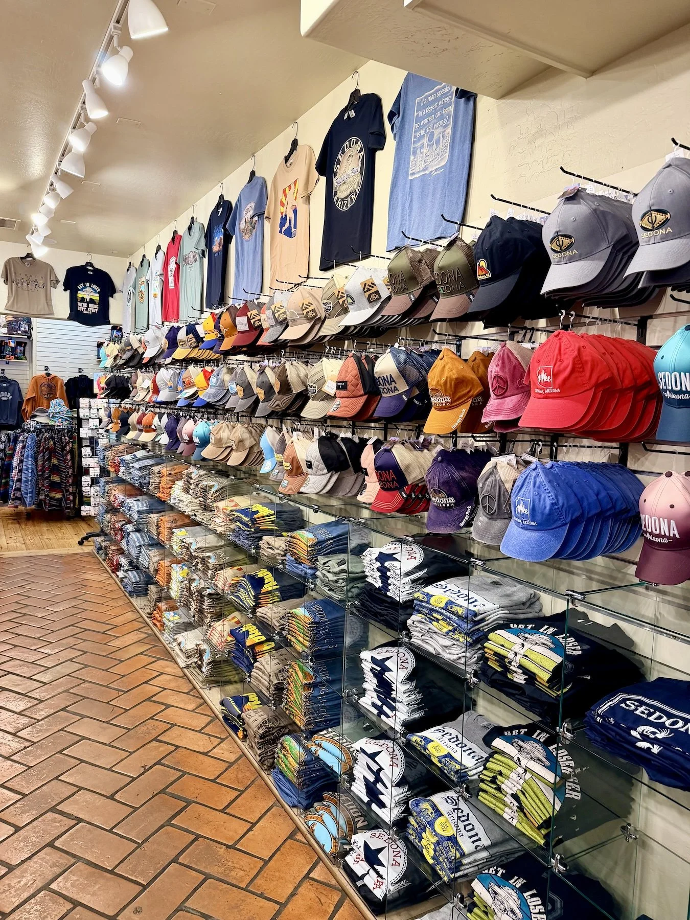 A display of baseball caps at a shop in the Sedona Center.
