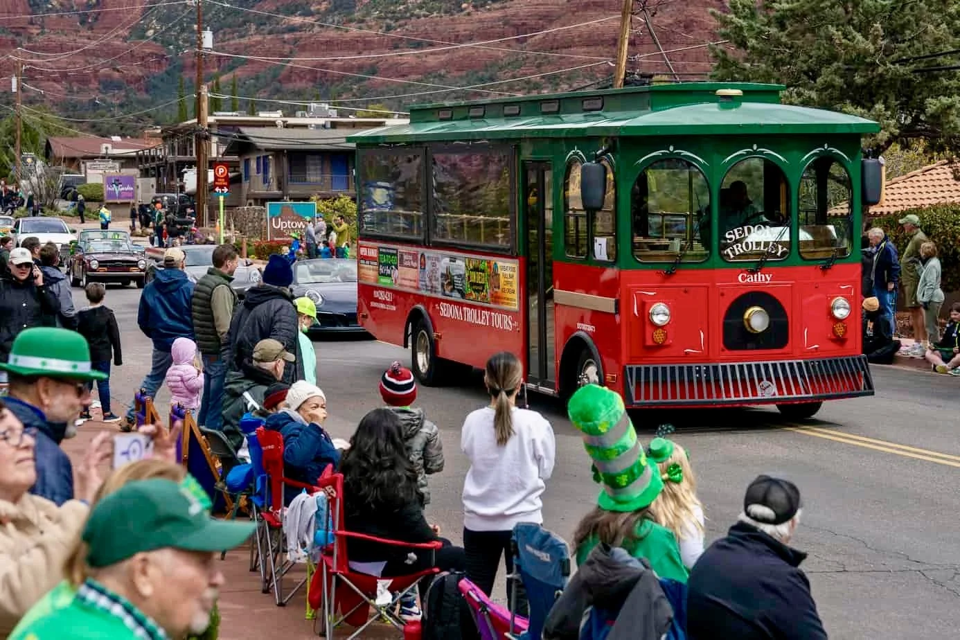 People in the crowd at a St. Patrick's parade look at the Sedona Trolley.