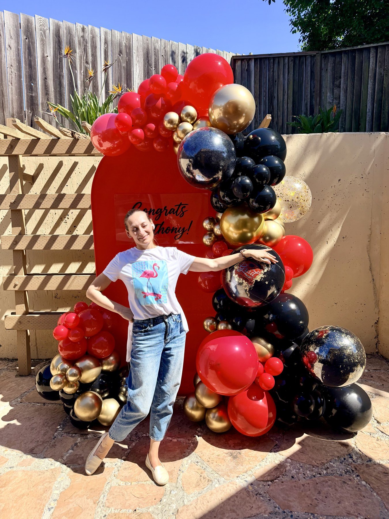 Graduation Balloon Decor in Hayward | Red, black and gold backdrop with Congrats Anthony lettering.