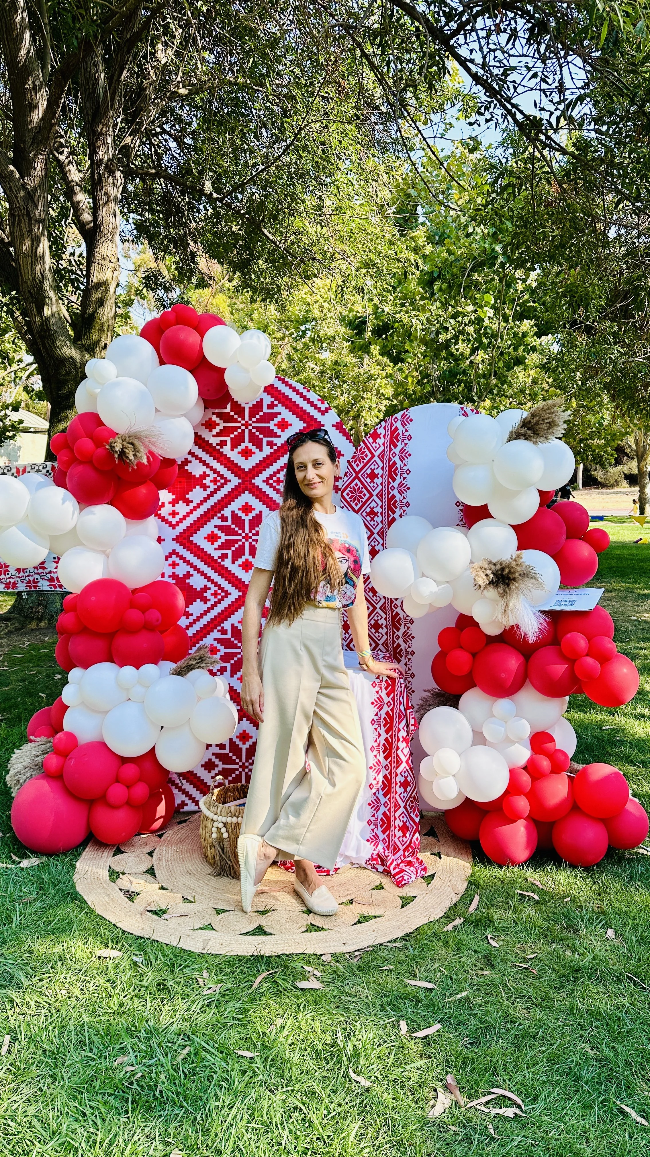Ukrainian Community Picnic in Sunnyvale | Red and white balloon photo backdrop.
