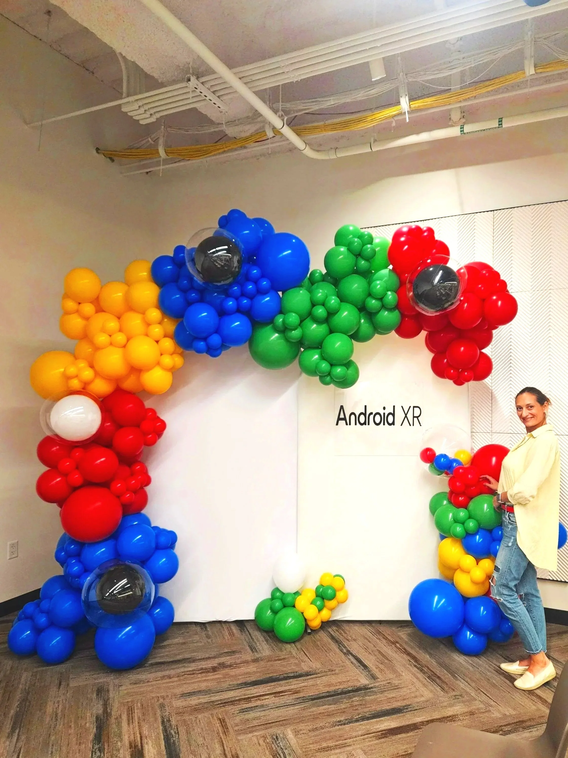 Corporate balloon arch installation for Android XR IT conference in San Francisco Bay Area, featuring Google-inspired colors — blue, green, red, and yellow.