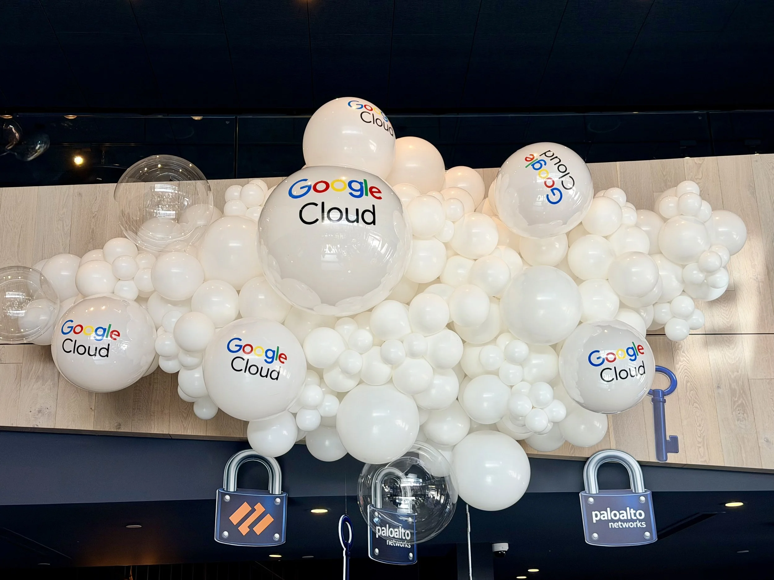 White branded balloon installation featuring Google Cloud and Palo Alto Networks logos at a corporate technology event in the San Francisco Bay Area.