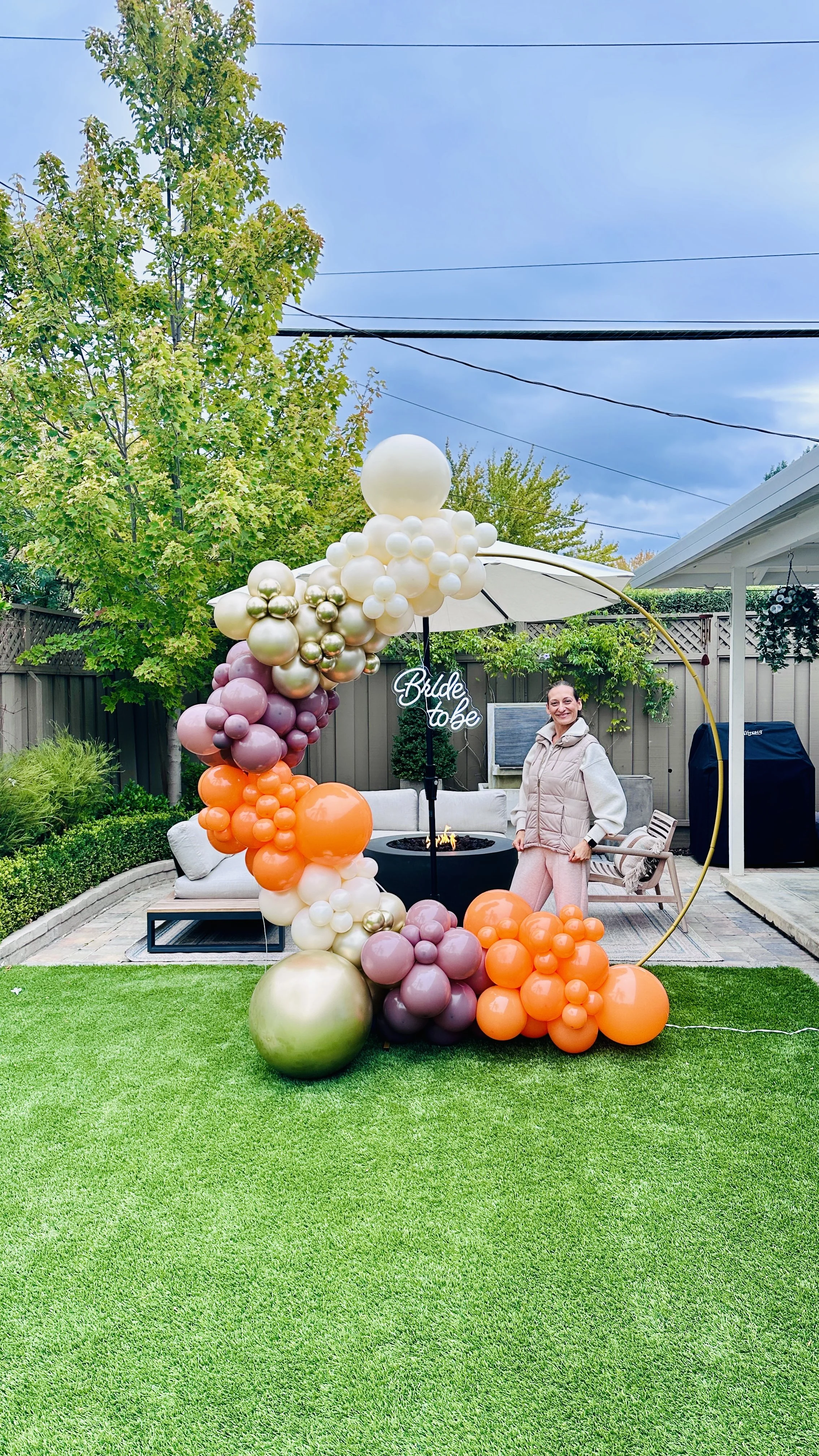 Backyard Bridal Shower in Santa Clara | Ivory, orange, mauve and gold balloon arch.