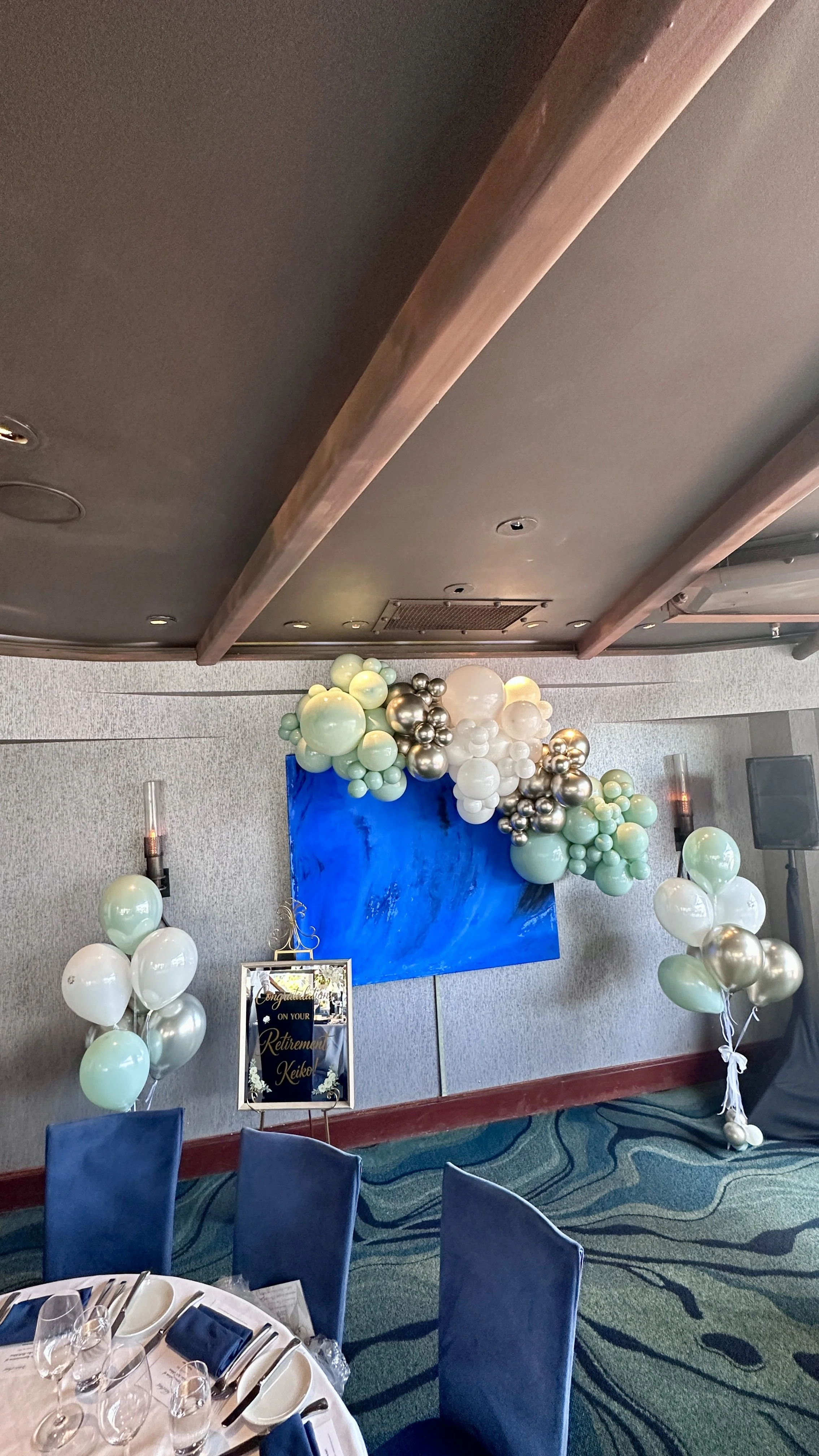 Mint and ivory helium bouquets and a gold-accented balloon garland for a San Mateo retirement party.