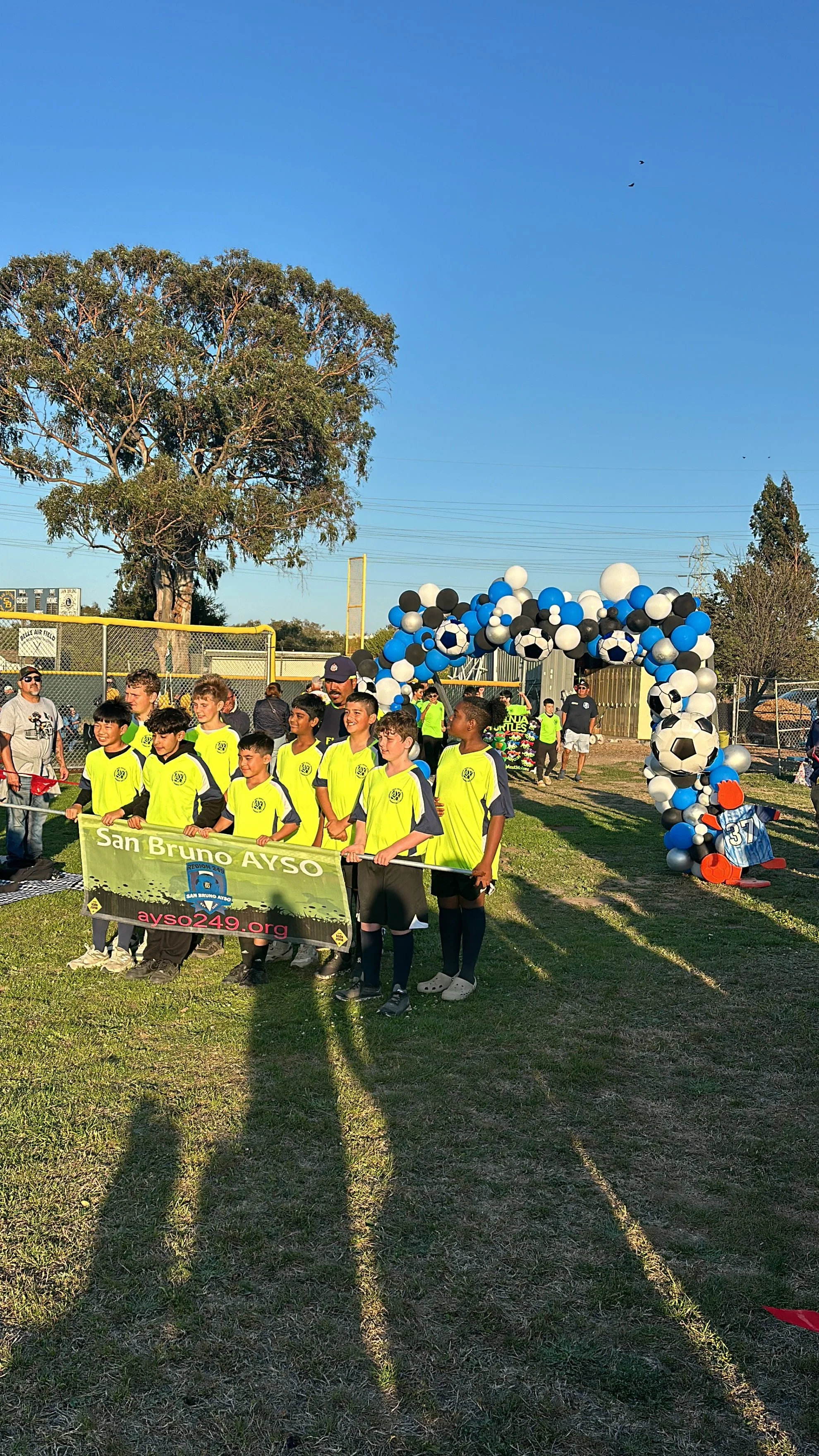 Outdoor soccer tournament photo area with a blue and white balloon goal arch in San Bruno.