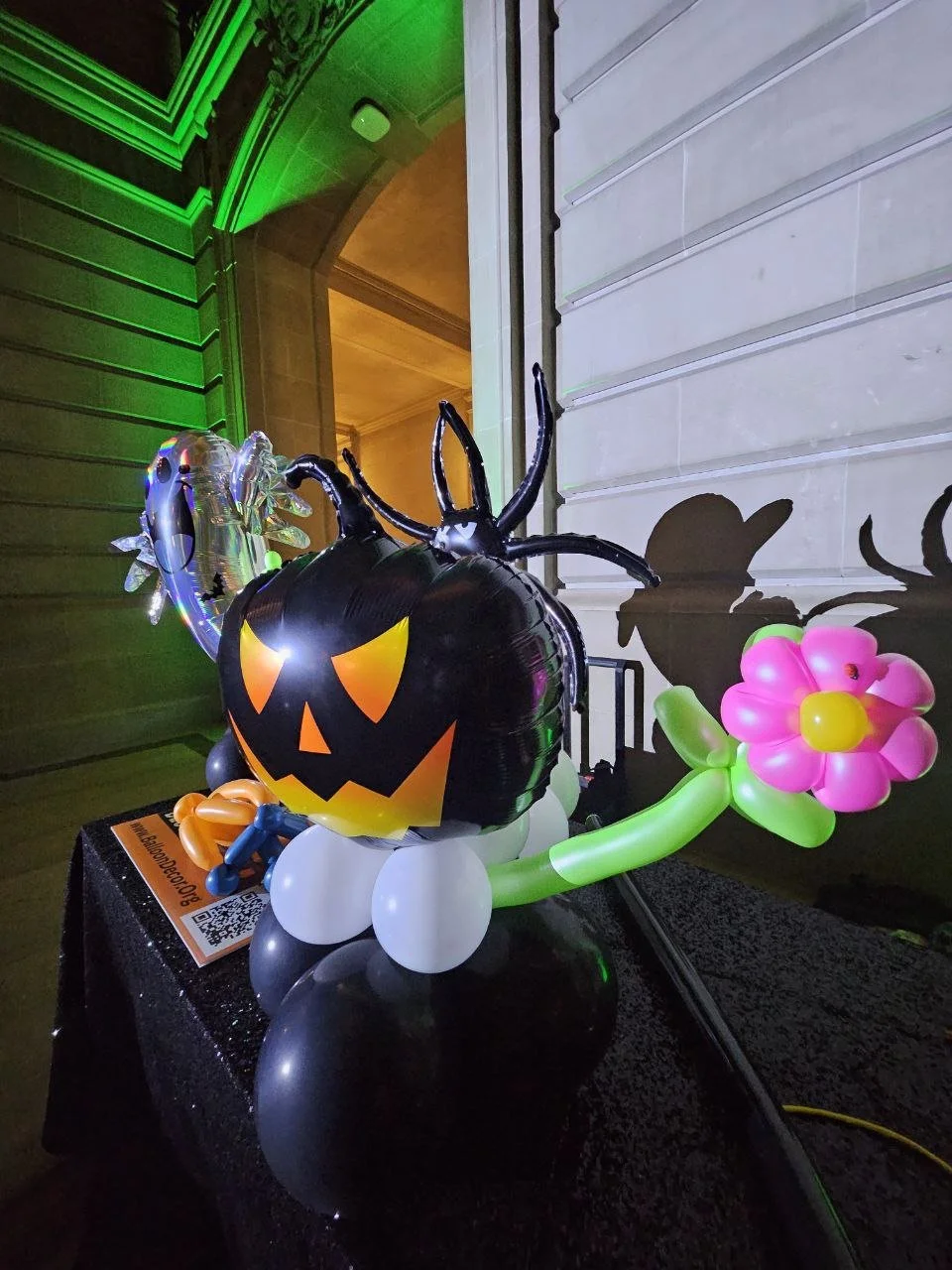 Jack-o-lantern, spider and flower balloon sculpture detail at a San Francisco City Hall Halloween display.