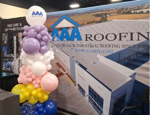 Branded balloon column installation at the AAA Roofing trade show booth in the San Francisco Bay Area.
