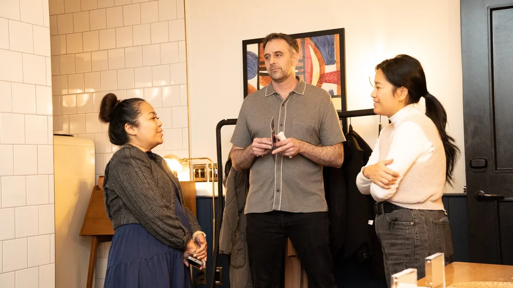 Guests at the Prologue backdrop