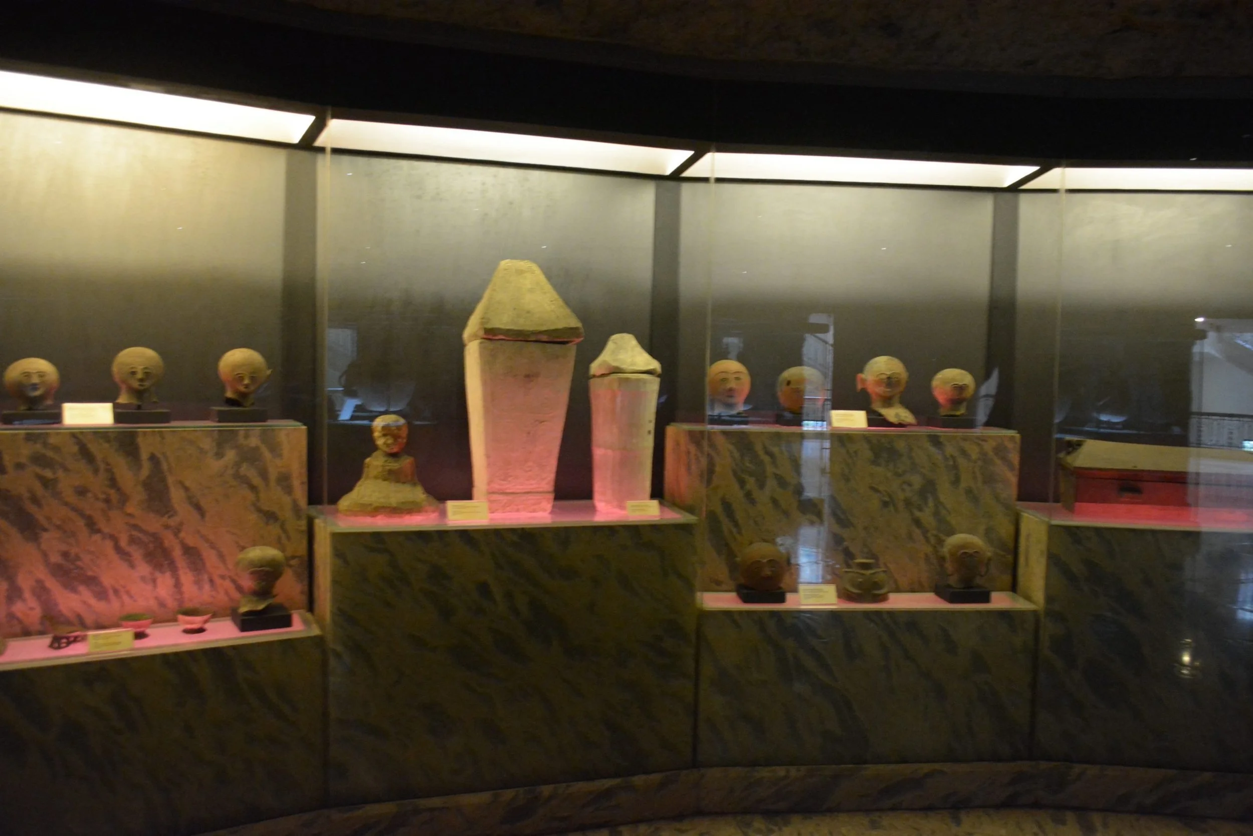 Precolonial burial jars and head-shaped jar covers on display at the National Museum of the Philippines