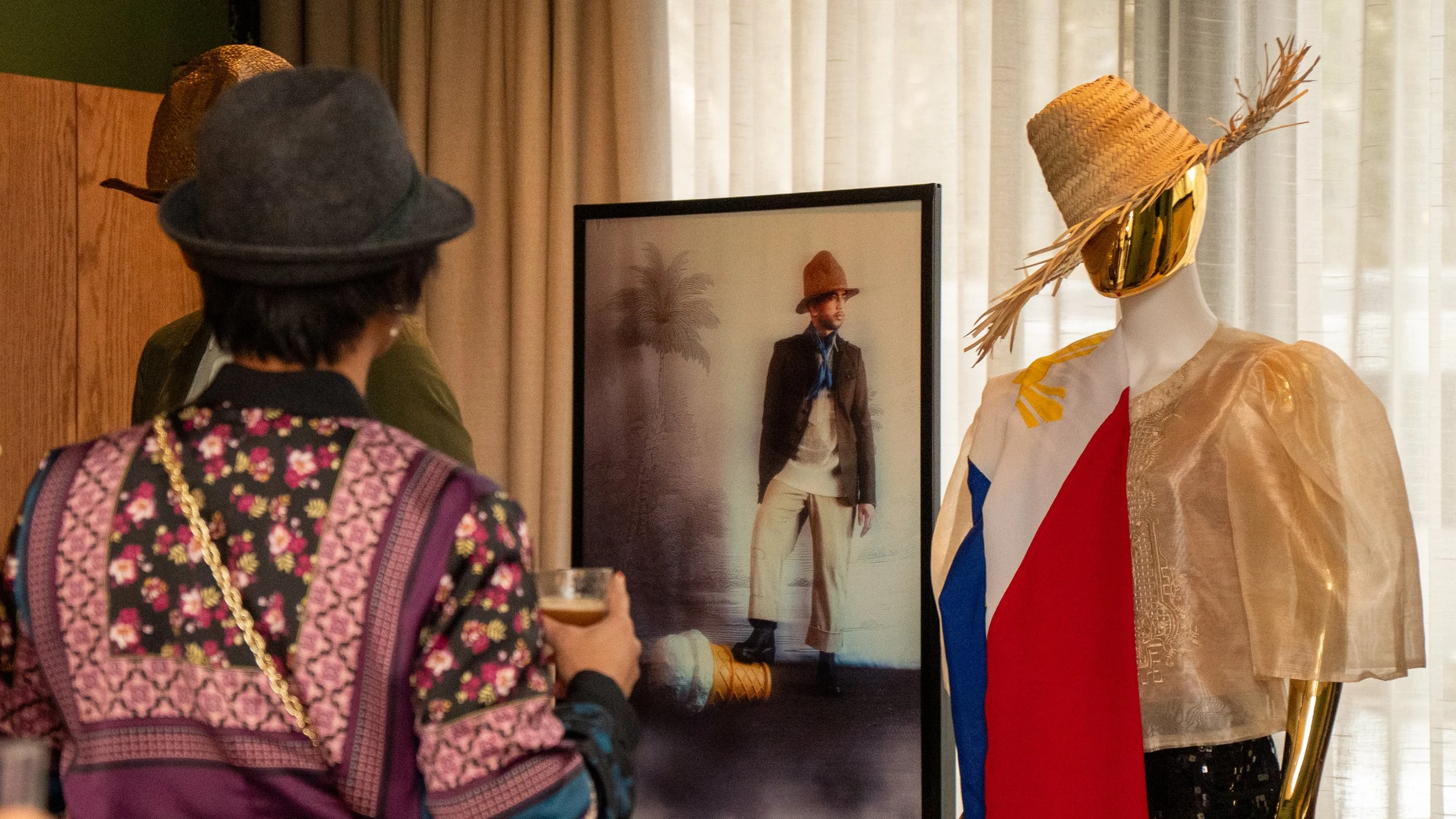 A guest at DIWA's Prologue exhibition takes in a styled barong display and framed portrait