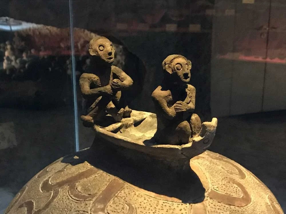 Lid of the Manunggul Jar showing two figures in a boat, souls paddling to the afterlife