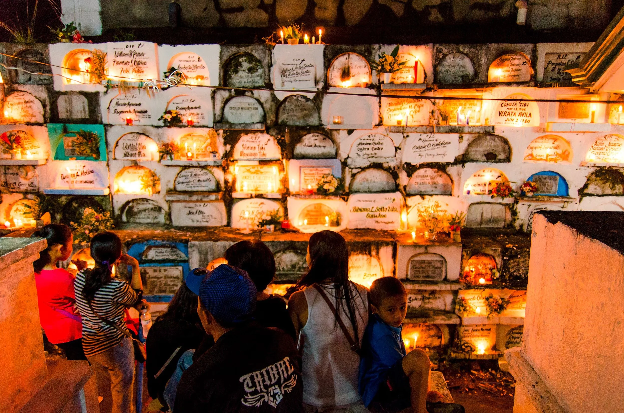 Families at candlelit tombs during Undas, All Saints' Day in the Philippines