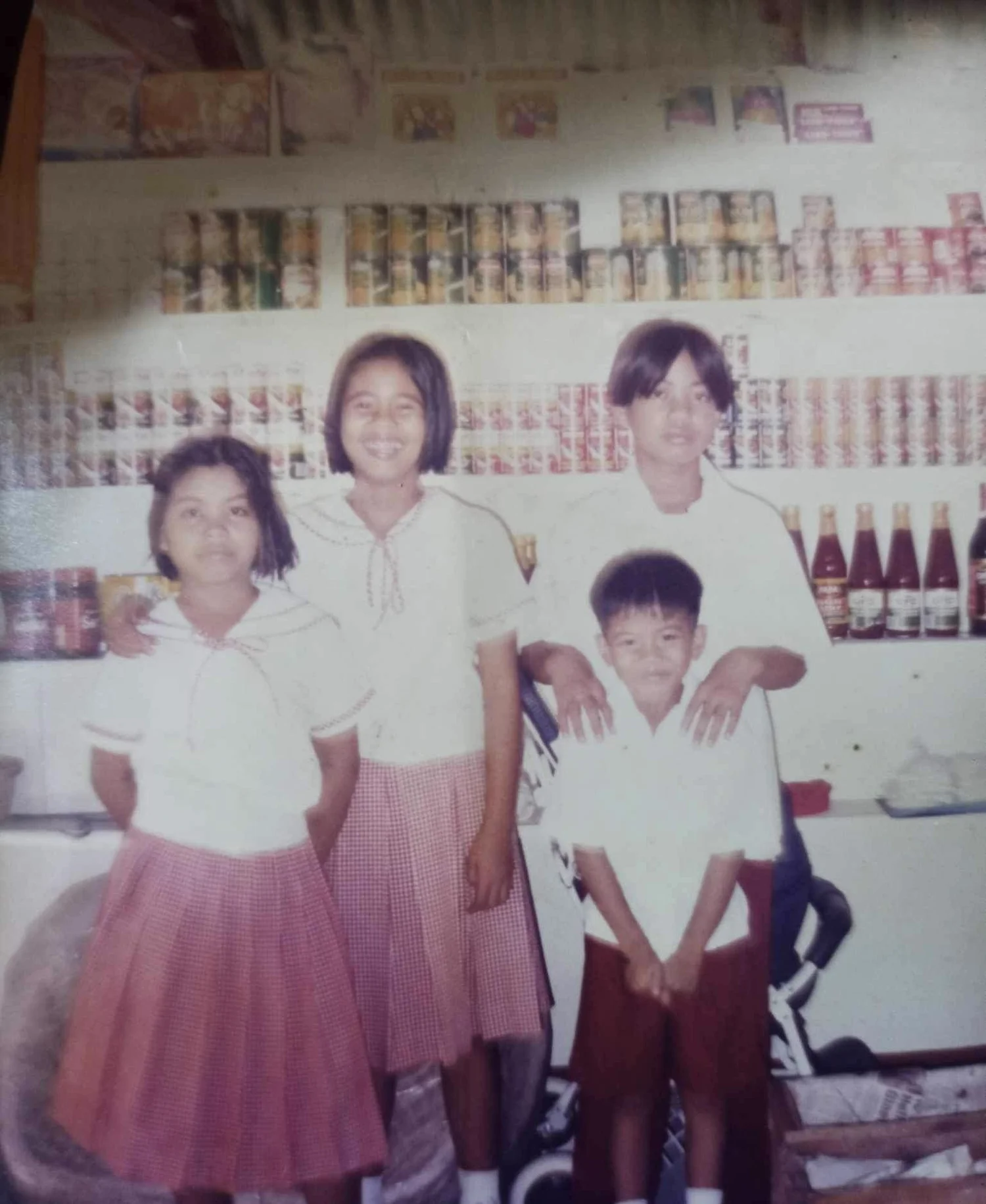 Four children in school uniforms before walking to school