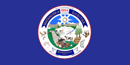 Flag of Matanuska Susitna Borough with an emblem featuring a dam, snow-capped mountains, trees, wildlife, and the year 1964.