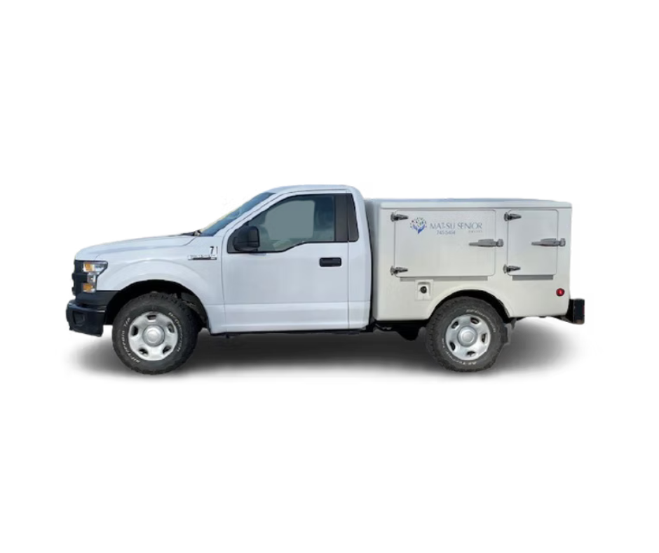A white utility truck with a service body, labeled 'Matsu Senor' and a phone number, isolated on a black background.