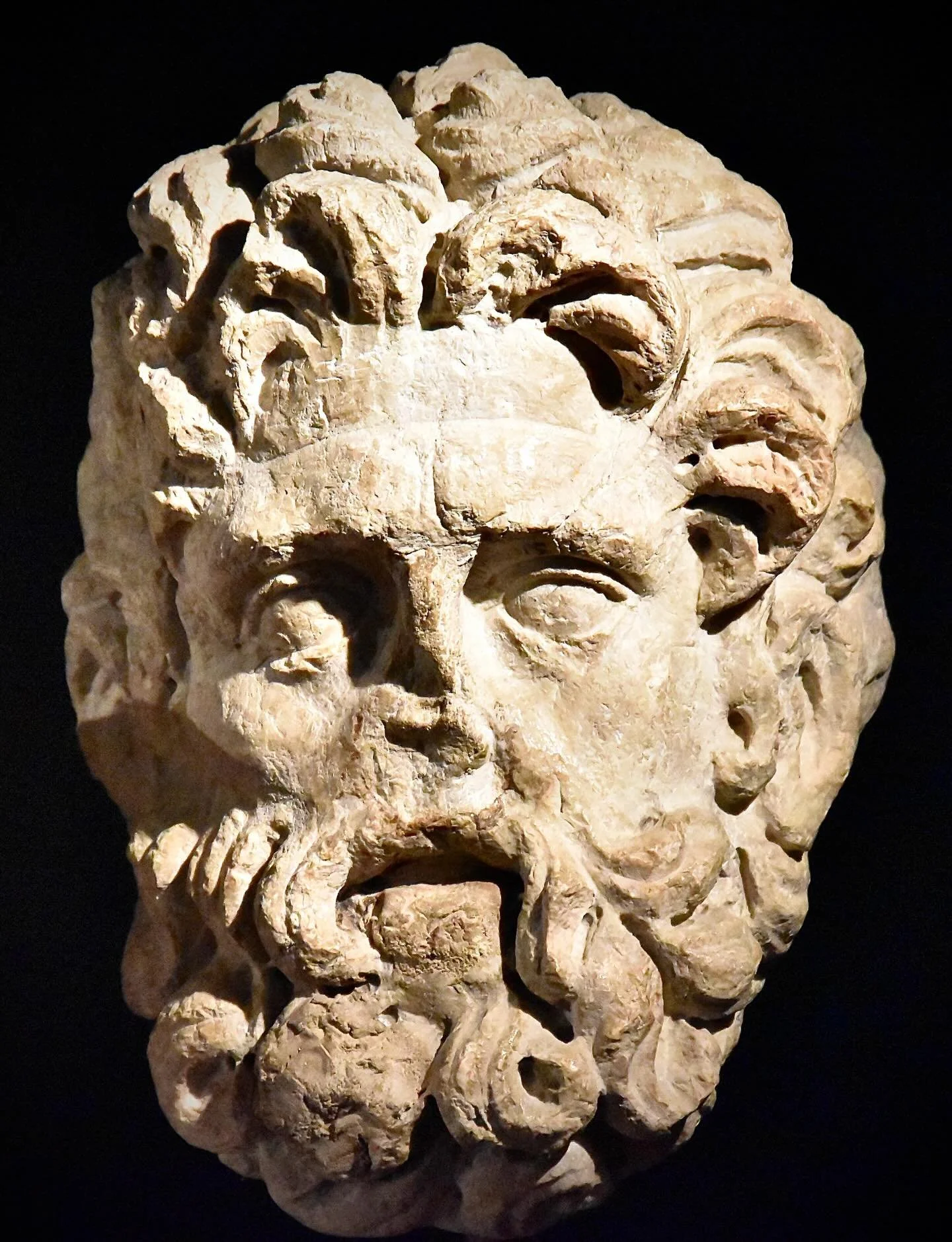 This bearded head, possibly representing the god Neptune, is a fragment of a high relief carved in Jura limestone and dated to the mid&ndash;2nd century AD. The piece may have formed part of the decoration of a sanctuary in the Roman town of Novodium