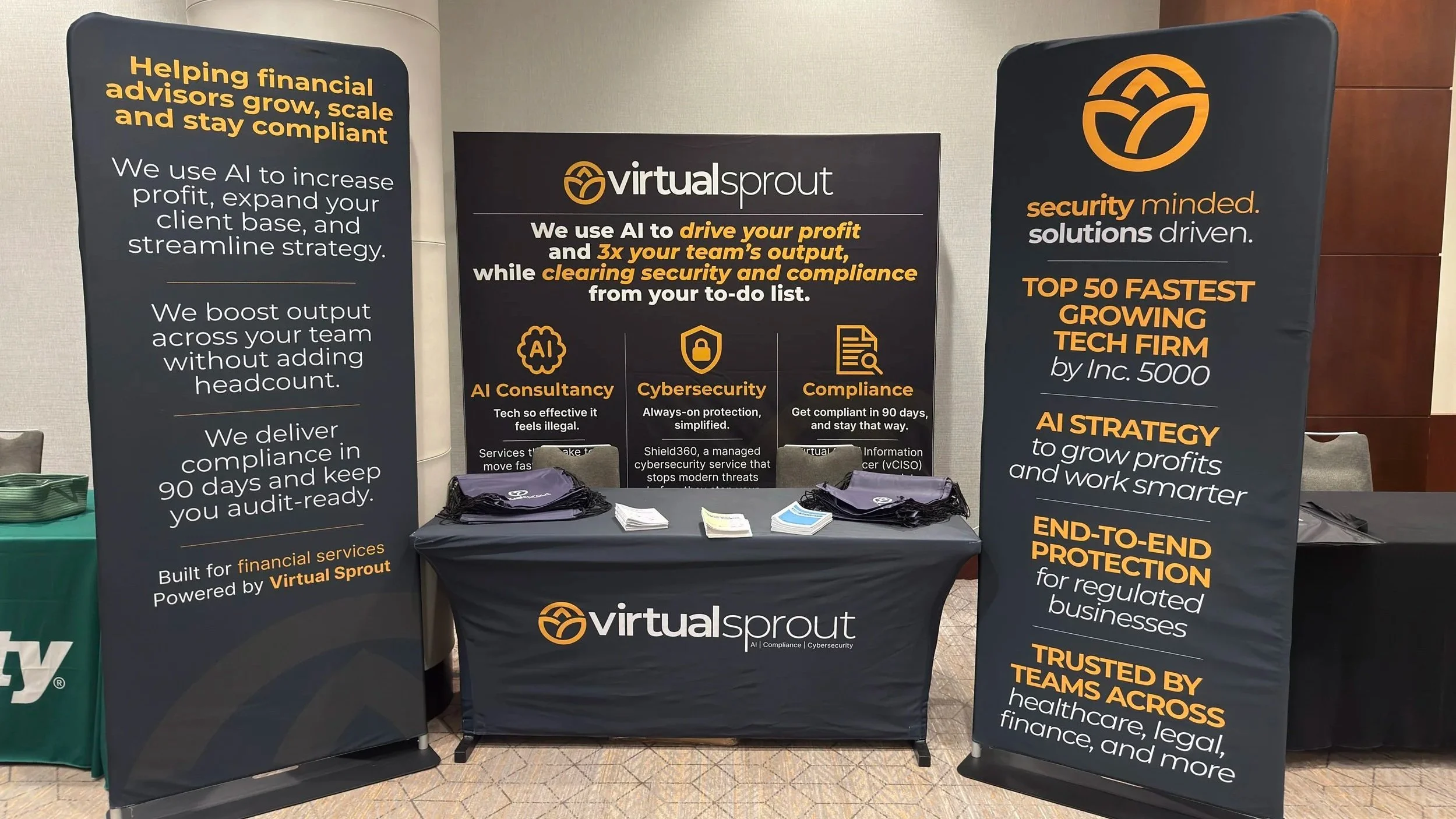 Trade show booth design in action (Washington, D.C., May 2025), featuring three custom banners and branded table wrap.