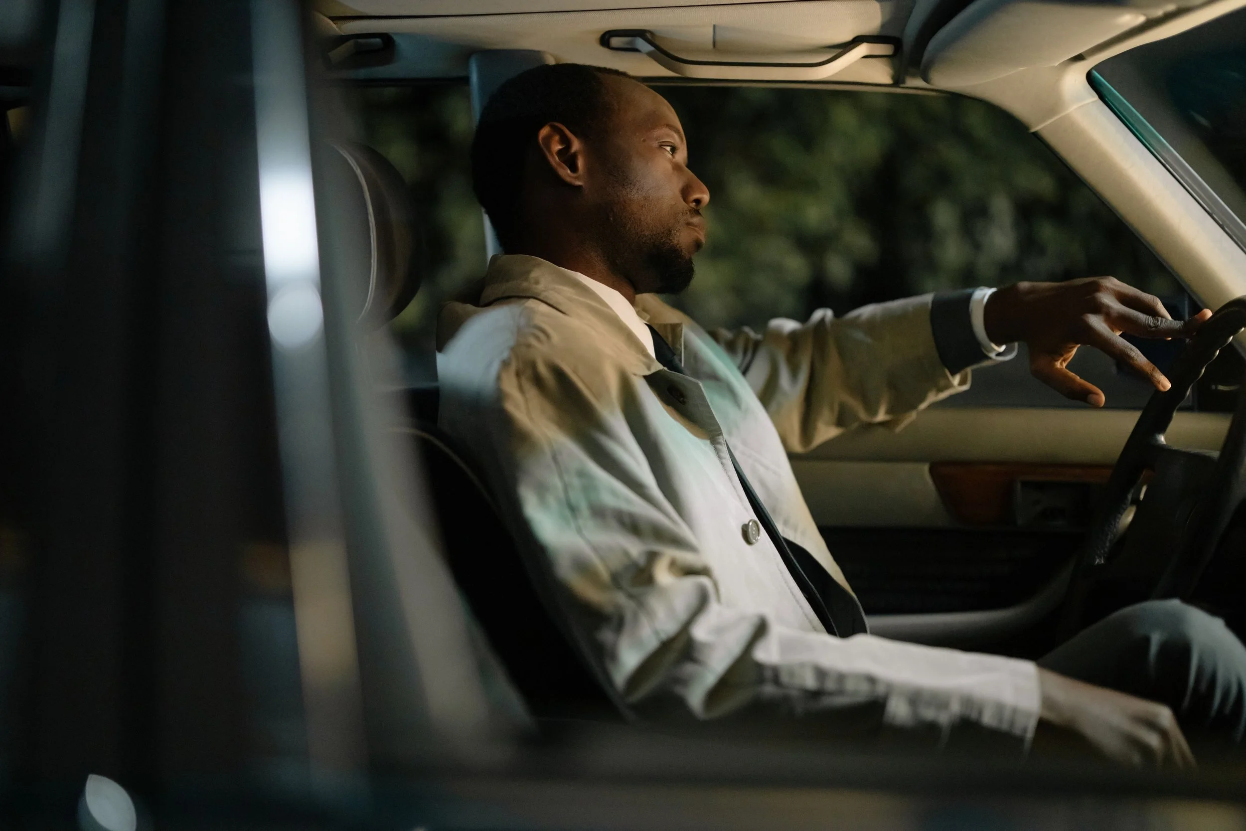 Person sitting alone in a parked car taking a break from people