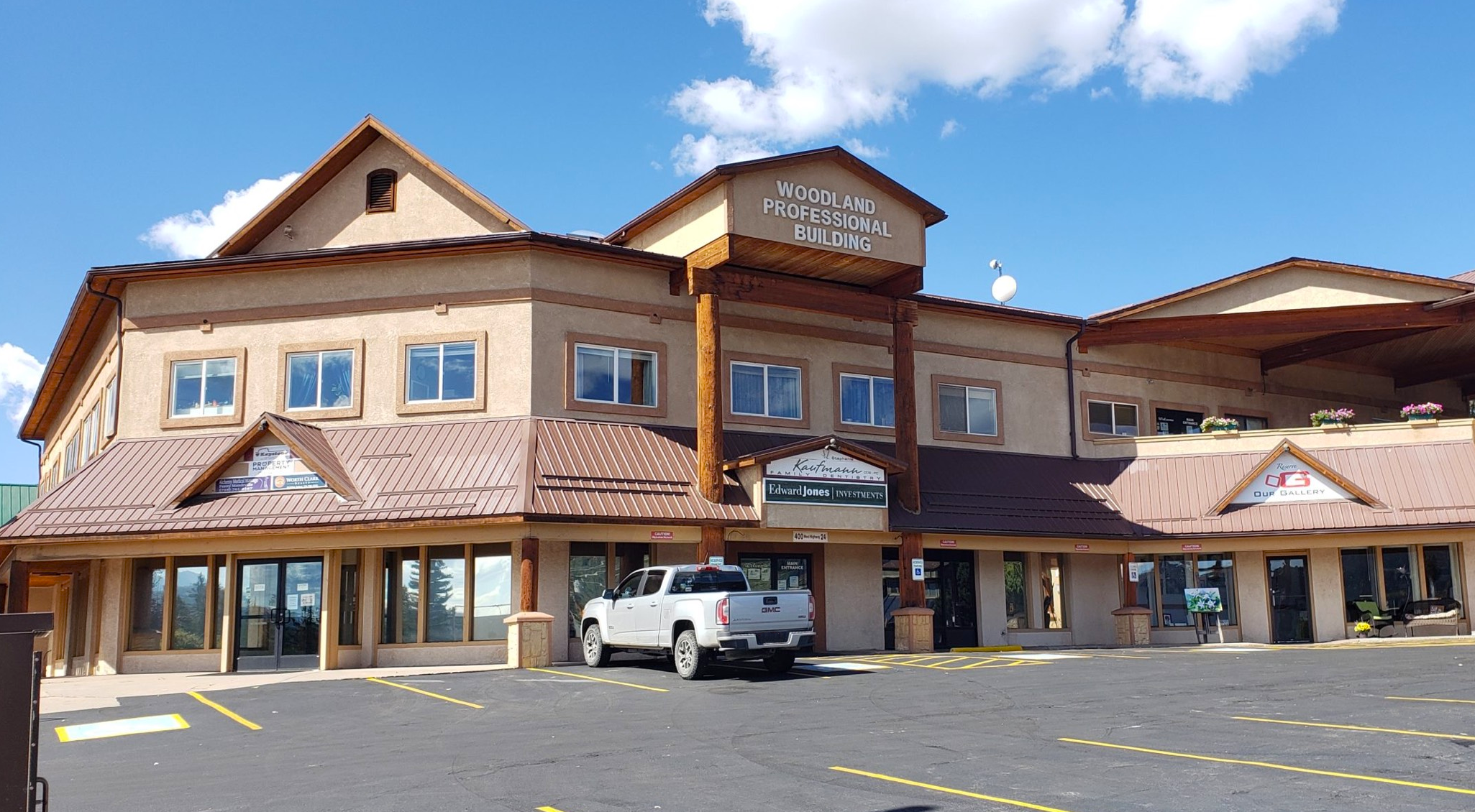 Front of the Woodland Professional Building that houses A Willow Bends Counseling Services in Woodland Park. Two-story building with stucco exterior and timber accents.